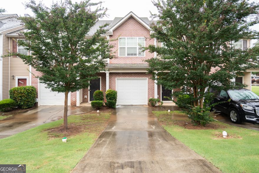 Welcome to 6010 Capitol Knoll - a charming, well-kept brick-front townhouse located in the heart of Fairburn, GA. Offering a comfortable layout and low-maintenance living, this home is move-in ready and full of value.    Step inside to an open-concept main level featuring a cozy family room with a fireplace and custom built-ins, ideal for quiet evenings or entertaining guests. The blend of hard surface flooring and plush carpet adds both warmth and practicality to the living space.    The kitchen is well-equipped with granite countertops, black appliances, a breakfast bar with seating, and ample cabinetry for storage. Whether you're preparing a weeknight dinner or hosting friends, this space works beautifully.    Upstairs, you'll find two spacious bedrooms with soft carpet and en-suite bathrooms, providing privacy and comfort for residents and guests alike. Fresh interior paint throughout adds a clean, modern touch.    Enjoy added convenience with a one-car garage, private driveway, and mature landscaping-professionally maintained by the HOA for easy, stress-free curb appeal.     Prime Location Highlights:   * Minutes from the Georgia Renaissance Festival and historic downtown Fairburn   * Close to Grady South Fulton (currently under construction)   * Easy access to I-85, shopping centers, dining, and everyday essentials   * Near local parks and green space for outdoor enjoyment    Whether you're a first-time buyer, downsizing, or looking for a smart investment property, 6010 Capitol Knoll offers a perfect blend of comfort, value, and location. Schedule your private tour today!