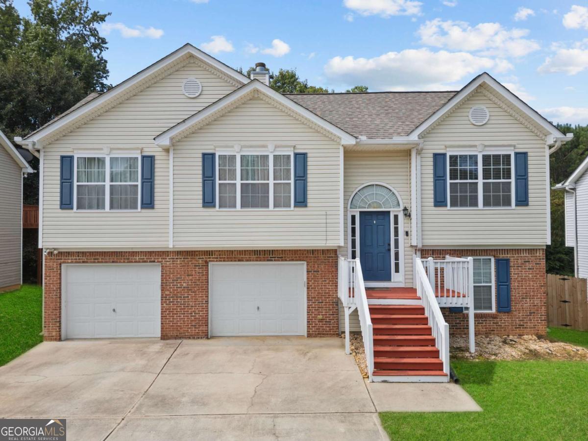 Charming 4BR/3BA home perfectly located just minutes from downtown Dallas & US-278! The open layout welcomes you with a spacious living room, cozy fireplace & bright eat-in kitchen. The main level features 3 bedrooms, including a serene primary suite with dual vanities, soaking tub & separate shower. The finished lower level offers a private bedroom, full bath & garage access-ideal for guests, a teen suite, or home office. Step outside to a fenced backyard with a raised deck & gazebo-style awning, perfect for relaxing or entertaining. Recent updates include a NEW HVAC & water heater (2022) and a 6-year-old roof. Close to schools, shopping & Silver Comet Trail-this home is move-in ready!