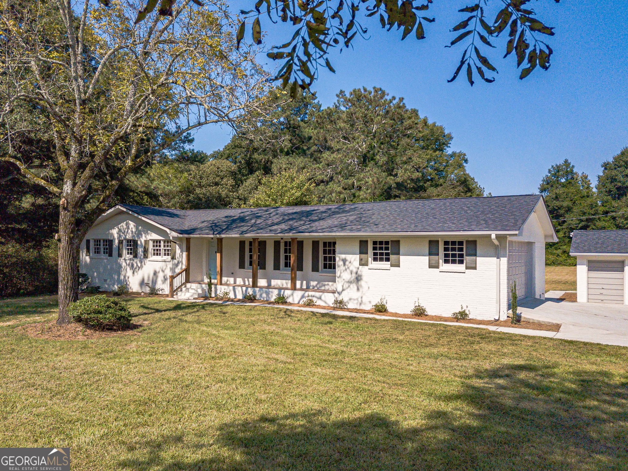 5.5% or Lower Interest Rate for Year 1 with Preferred Lender! Welcome to your peaceful retreat on 2 level acres in the sought-after Loganville school district! This beautifully updated ranch home offers 3 bedrooms, 2.5 baths with an open, inviting floor plan plus a detached garage/workshop. Step inside to find a bright and airy living space centered around a cozy fireplace. The designer kitchen features crisp white cabinetry, granite countertops, stainless steel appliances, a custom vent hood, and walk-in pantry. The primary suite is a true escape with a walk-in closet, dual vanity, and a spa-inspired tiled shower. Two additional bedrooms share a stylish full bath, and there is a convenient half bath ideal for guests. Every detail is NEW roof, septic lines, water heater, flooring, cabinetry, granite, appliances, plumbing fixtures, lighting, garage door, interior/exterior paint, and more giving you total peace of mind. For those who need space to work or play, the home offers both an attached garage and a detached 3-bay garage/workshop. Outside, relax or entertain under the covered patio or enjoy the wide-open yard perfect for putting in your own pool! With serene surroundings just minutes from Loganville's conveniences, this move-in ready home truly has it all!