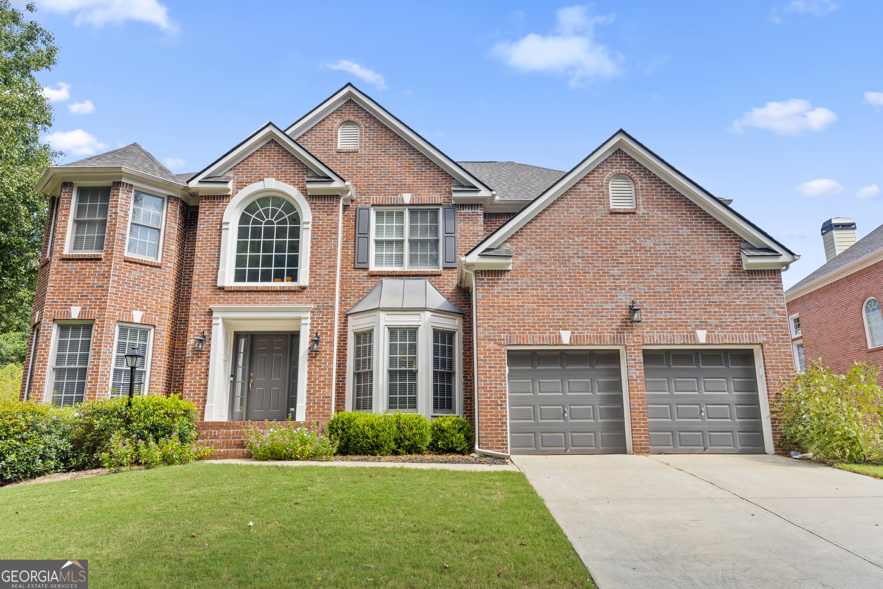 Step into a spacious sanctuary at 141 Ennisbrook Drive Southeast in Smyrna, GA. Nestled in a gated community, this impressive home features 6 bedrooms and 5 bathrooms, sprawling across 5,334 square feet. The main level offers a formal dining room perfect for entertaining and a home office or additional bedroom for your work-from-home needs. The chef's kitchen flaunts quartz countertops and an expansive island, ideal for both cooking and casual dining. French doors open to a large deck, where you can unwind overlooking your private outdoor space. Head to the upper level to discover a lavish primary suite, complete with dual walk-in closets and a luxurious ensuite bath. The finished basement serves as a media/recreation room, complete with a built-in bar-an ultimate entertainment hub. Beyond the home, the community boasts amenities like a pool, tennis and basketball courts, and a playground-everyone's idea of fun is just a stroll away. Discover the perfect blend of modern living and serene comfort in this remarkable home. Make it yours and become part of a vibrant community that offers the best of amenities and personal space.