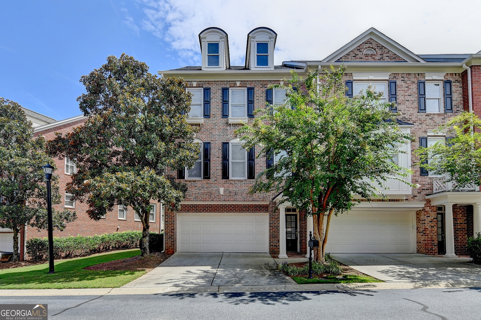 This exquisite end-unit townhome is situated in the highly sought-after Vinings Estates community. Hardwood floors are featured throughout. Enjoy an open and spacious floor plan boasting 4 bedrooms, 3 full baths, and 1 half bath. Additional features include a 2-car garage with extra storage space. The expansive main level showcases an eat-in kitchen, open dining area, sunroom, and private deck access. The top level offers a primary bedroom with sunroom, large walk-in closet, double vanity, separate shower, and tub. Two additional bedrooms and a full bath complete this level. The lower level/walk-in level features a bedroom with full bath. This community boasts an array of amenities, including 3 pools, 2 clubhouses, 8 lighted tennis courts, basketball court, playground, and owner will consider 6-month lease for additional rent. A minimum 650 credit score and no evictions are required.