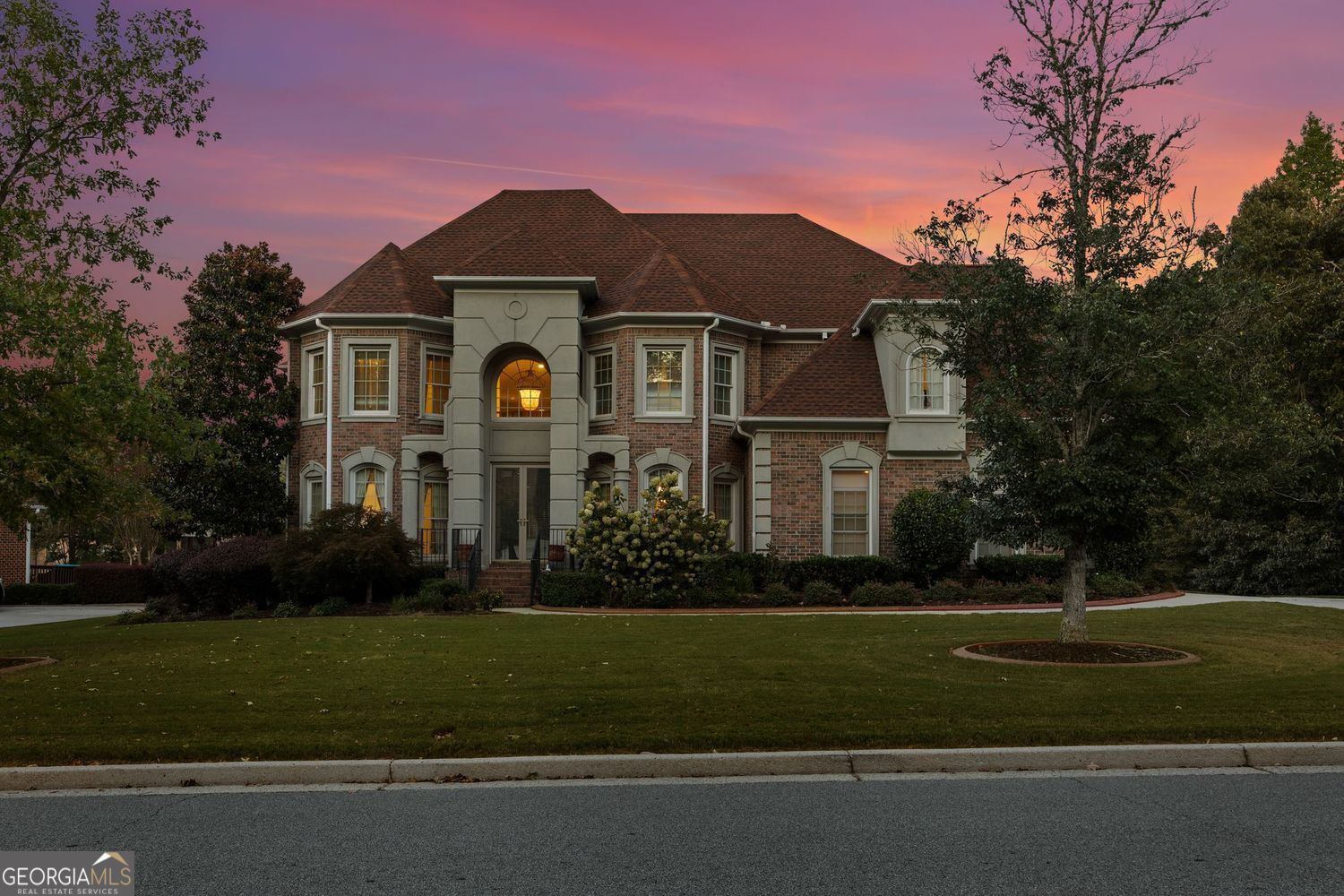 Welcome to The Estates at Guilford Forest, one of Southwest Atlanta's most prestigious communities, where elegance and tradition meet modern luxury. This stately John Weiland home is perfectly positioned on an expansive lot, boasting the largest backyard in the neighborhood - ideal for outdoor living, entertaining, and creating your own private retreat. Step inside to a grand foyer with a sweeping staircase that sets the tone for timeless sophistication. The open floor plan offers abundant natural light and seamless flow, highlighted by a spacious family room with a cozy fireplace and soaring ceilings framed by dramatic windows. The gourmet kitchen is complete with a butler's pantry, perfect for hosting and entertaining, and flows effortlessly into the formal dining room and breakfast area. Upstairs, retreat to a luxurious owner's suite, while secondary bedrooms provide comfort and versatility for family or guests. Enjoy outdoor living at its finest on the deck, overlooking the unmatched backyard space - one of the community's crown jewels. With thoughtful details throughout, a three-car garage, and the prestige of living in Guilford Forest, this home blends traditional architecture with modern comforts in an unparalleled setting.