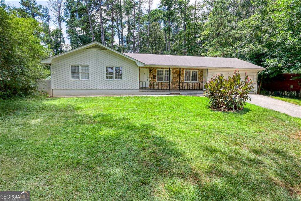 Charming 3 bedroom 2 bath rancher. Beautiful kitchen with granite counter tops, stylish grey cabinets and hardware, tasteful backsplash tiling, and stainless appliances. Hardwoods throughout, no carpet. Tiled sunroom with lots of windows provide sun soaked light for your tranquil oasis. Bricked back patio great for gatherings and enjoying relaxing time outside. Backyard has plenty of space for additional gardening. Stone fireplace in living room.