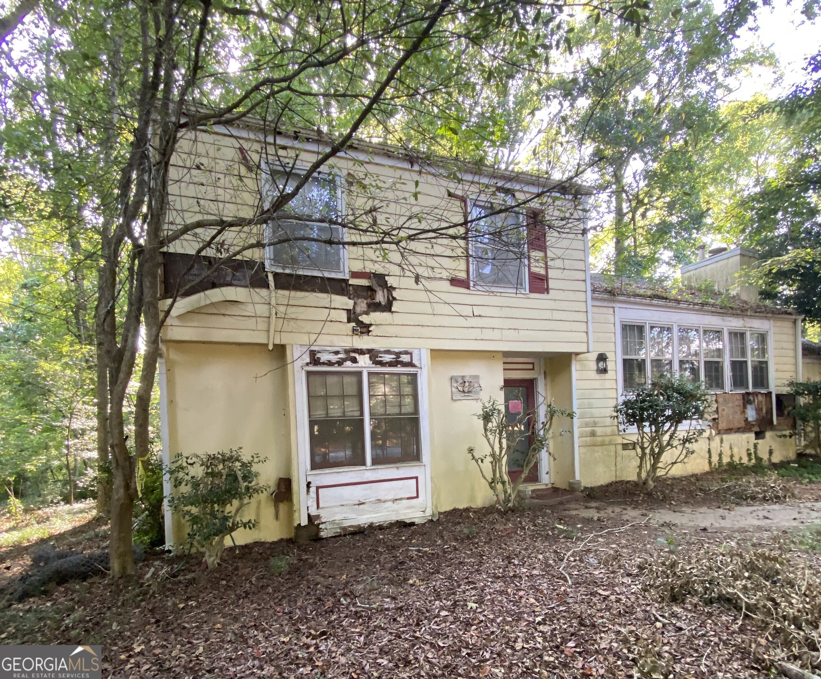 Priced to sell! Conveniently located! Discover a unique investment opportunity with this charming fixer-upper nestled on a spacious one acre lot. This split level home, surrounded by lush greenery and mature trees, offers tremendous potential for the right buyer. Featuring a classic design with large windows, a welcoming front entrance, and a generous yard, this property is ideal for renovation or redevelopment. The home requires significant repairs, including exterior siding, windows, complete interior renovation, and landscaping, presenting a canvas for your vision-whether as a personal residence, rental property, or custom build. Located in a desirable Fayetteville area with easy access to local amenities, this is a rare chance to own and transform a property with character. Sold as-is.