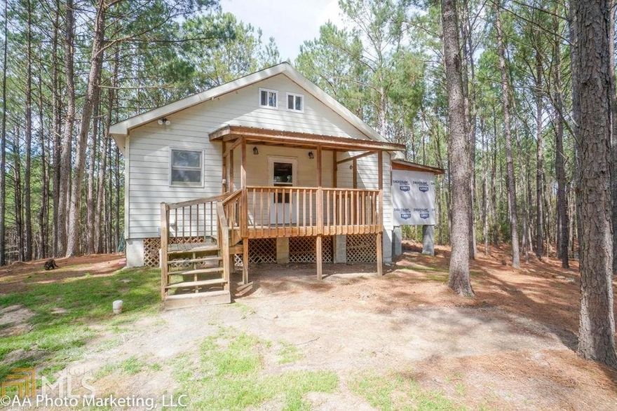 WOW! A true ONE OF A KIND property. 21 acres with 2 ponds. Main house features open floor plan with kitchen, dining, living/bedroom combo with loft area. Addition for master bed & bath started, but not completed(adds approx 400 sq ft). Rustic charm throughout home-reclaimed floors & tin decorate much of the home. Large deck provides gorgeous view of land. Separate cottage adds approx 400 sq ft of living with bed, bath, kitchen, & living area. Large wired shop. Additional shop! Call for so much more info!!