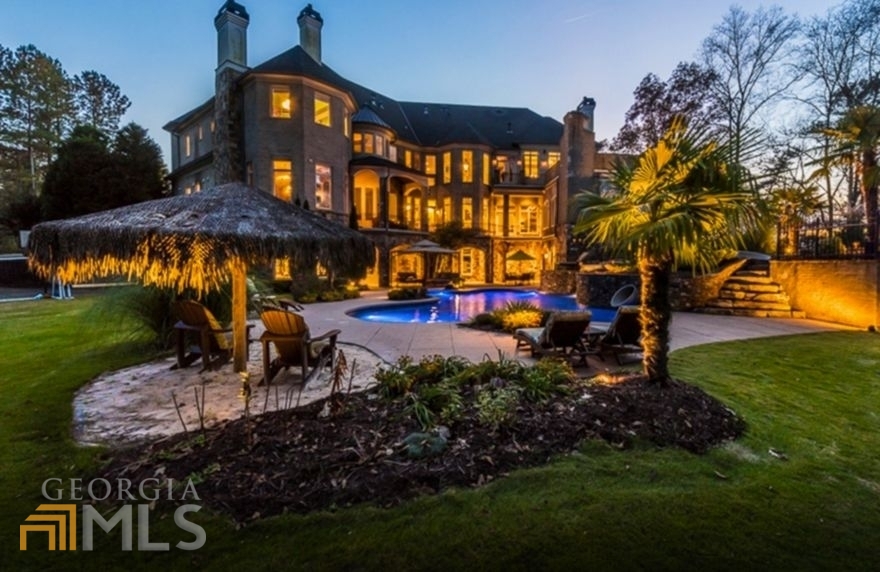 Newly renovated estate on 3 acres secured behind double iron gates for the ultimate privacy and protection. The property overlooks beautiful woods and pastures and is perfect for entertaining and resort-style living, it even has private access to acres of deeded trails for hiking, biking and ATVs. A rare find in close-in Milton! Built and renovated by Atlanta's #1 luxury custom homebuilder. The bright and open floor plan features a grand master wing, his and her offices, professional kitchen, 2 laundry rooms, 11 fireplaces, and an exquisite pool complete with waterfall, hot-tub and slide. Terrace level with bar, living room, professional workout room, movie theater, kitchens, game rooms and plenty of storage. Additional 8 acres available, horses welcome. Close to shopping and dining hot spots: Avalon, downtown Crabapple, Alpharetta and Roswell Square. Excellent Milton schools and close to several country clubs. POF required for all showings.