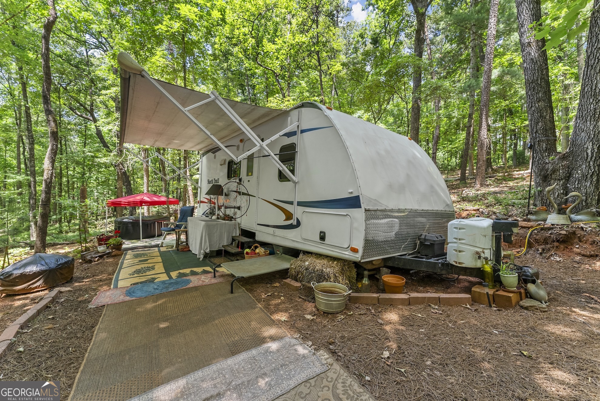 Private, unrestricted 3+ acre oasis ready for your forever home! Driveway has been roughed in, underground power and Internet on property. All you need are your building plans! Extremely close to Lake Burton, secluded and private setting. Camper is included!