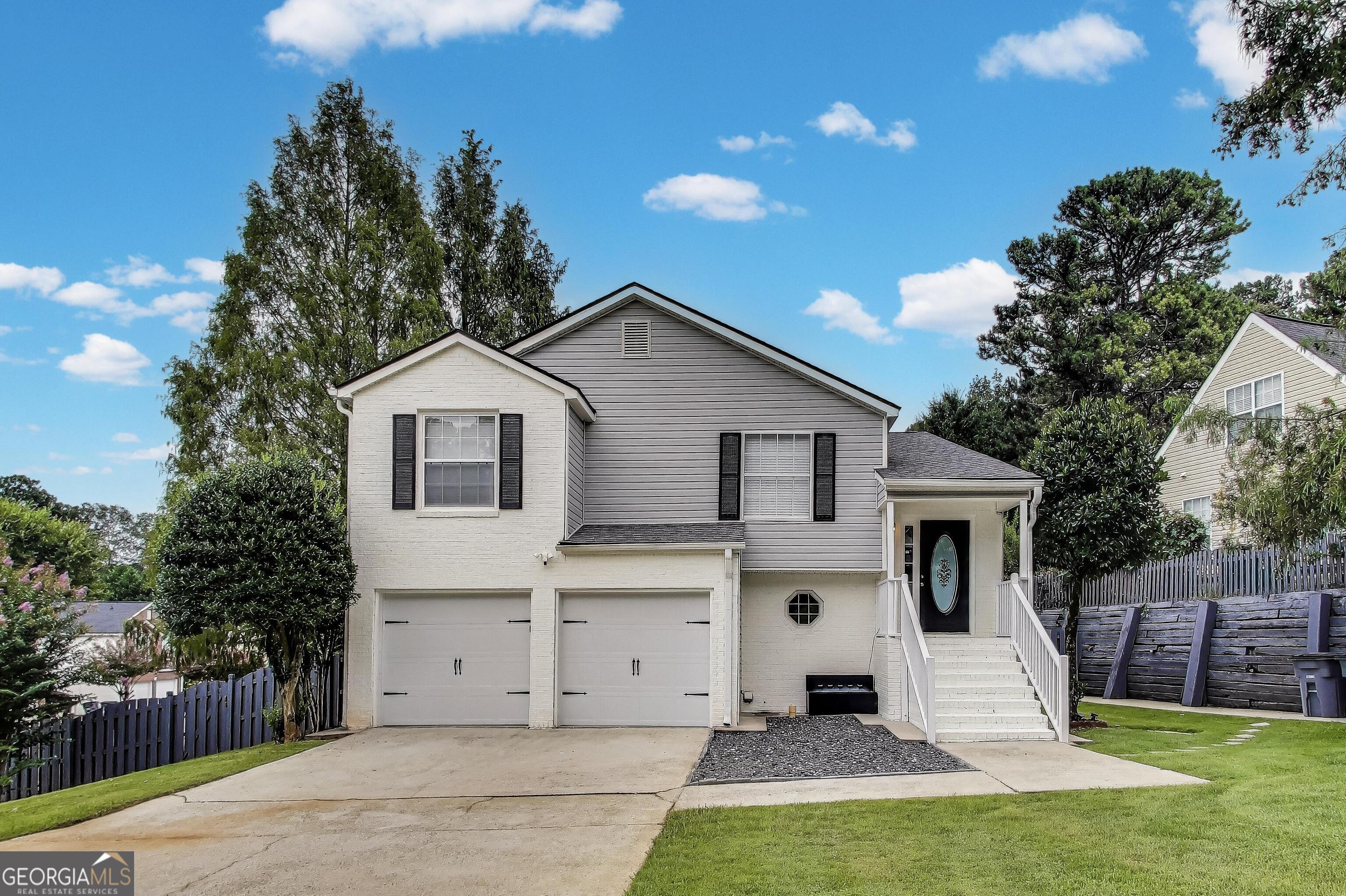 This stunning home was completely renovated in 2022 from the floor up, offering the perfect blend of modern upgrades and spacious comfort. NO HOA. Featuring 5 bedrooms and 3 full bathrooms with over 2,200 square feet of living space, this property is ideal for a large family or anyone who enjoys frequent gatherings. Sitting on a private corner lot with 0.22 acres, the home offers both privacy and convenience, with a fenced backyard, a large front yard, and a two car garage complete with new garage doors and a huge driveway. The roof and A/C are only three years old, giving you peace of mind with these major updates already taken care of. Inside, the split level layout provides great versatility. The downstairs features two generous sized bedrooms, a full bath, and plenty of space that could easily be converted into a second kitchen, making it a great option for renting out or accommodating extended family. Upstairs, the open concept design connects the kitchen, dining, and living areas seamlessly, highlighted by real hardwood flooring and modern light fixtures throughout. The kitchen has been updated to perfection with quartz countertops, recessed lighting, and sparkling modern fixtures, paired beautifully with high end stainless steel appliances including a convection oven and range hood. The master suite is a true retreat, featuring an immense walk in closet and a spa like bathroom with quartz countertops, a stunning ceramic shower with glass doors, and a thoughtfully designed layout for comfort and style. Additional bedrooms are spacious, with clean carpet and plenty of natural light, while the hallway bathroom has been fully remodeled with elegant white tile and glass shower doors. Step outside to enjoy the back deck overlooking the private, fully fenced backyard, perfect for relaxing evenings or entertaining guests. With fresh paint inside and out, this home feels brand new and ready to move in. Located just two minutes away from John R. Lewis Memorial Park, Tom E. Morris Sports Complex, and the Porsche Center, and within walking distance to all your favorite stores, restaurants, and salons, the location is unbeatable. The area is rapidly growing with new construction and development, making this not only a beautiful home but also a smart investment. Don't miss your chance to own this exceptional property in such a blooming historic community. Schedule your tour today and see why this home is truly special.