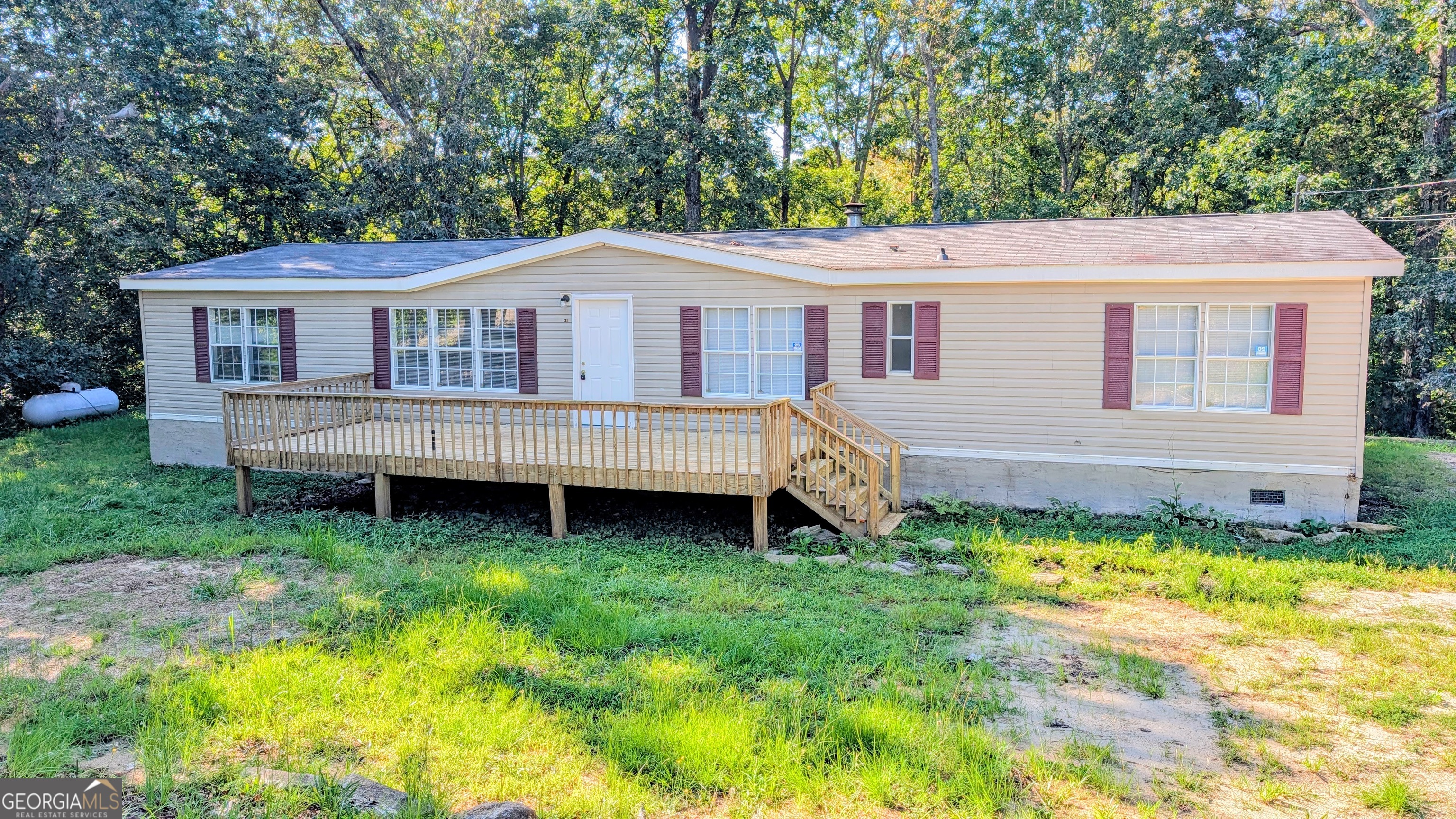 Four bedroom ranch on over one acre in Dahlonega! Spacious floor plan with split bedroom layout. Additional den with pretty black painted stone wood burning fireplace. Laminate flooring throughout. Master bath has a soaking tub and walk in closet. Laundry closet / mudroom conveniently off the kitchen. House is on a permanent foundation and is being sold as is. Minutes from downtown Dahlonega, shops, restaurants and UNG. Property has been a long time rental. Rent rolls available on request.