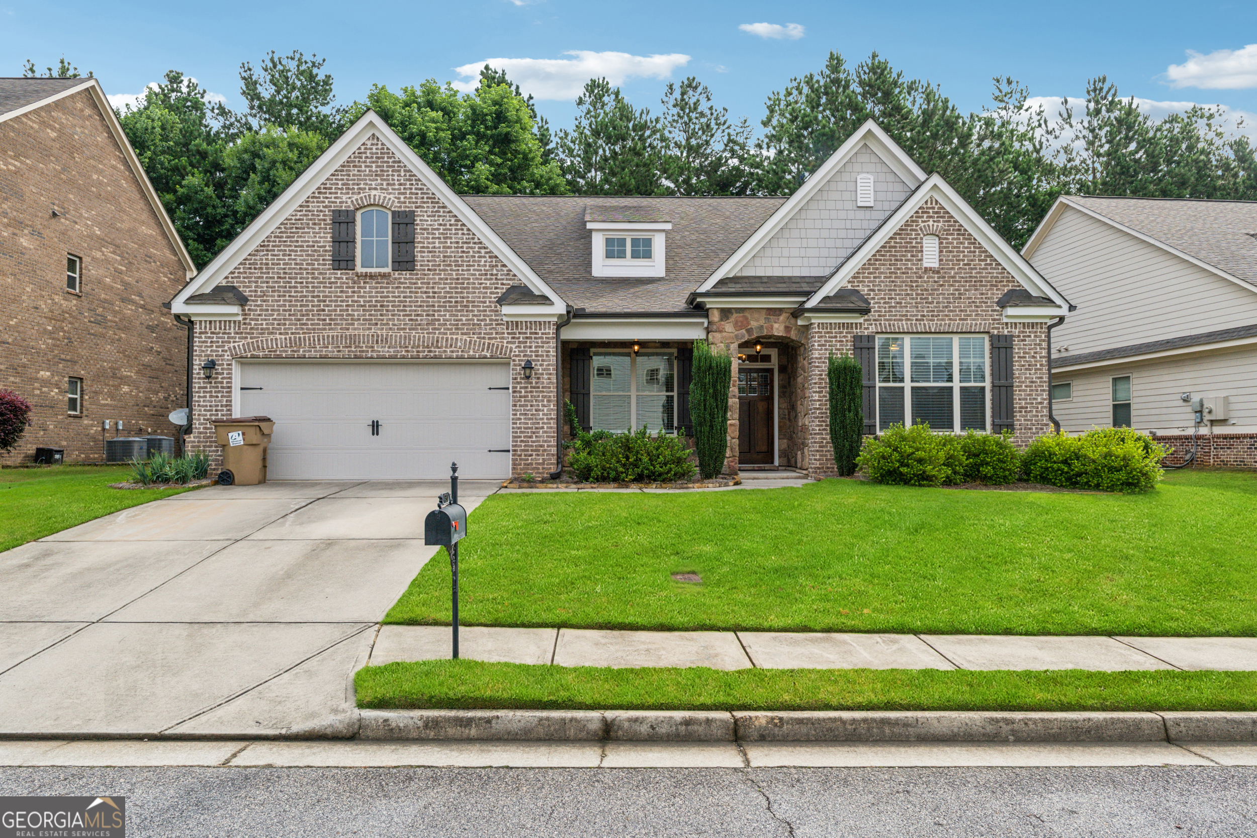 Stunning Home in Sugar Hill / Ashford Crossing. Welcome to this beautifully designed home that offers the perfect blend of comfort, space, and functionality. The primary suite is conveniently located on the main floor, featuring a luxurious oversized shower with dual shower heads for a spa-like experience. Two additional bedrooms on the first floor make this layout ideal for multigenerational living. Upstairs, you'll find a spacious fourth bedroom along with a generous bonus room, perfect for a playroom, media room, or guest retreat. The main living areas are open and expansive-perfect for both everyday living and entertaining. A dedicated home office on the first floor offers flexibility for remote work, homeschooling, or a creative studio. At the heart of the home is a large chef's kitchen with an oversized granite island that comfortably seats six-ideal for casual meals and gathering with friends and family. Step outside to a perfectly sized backyard featuring built-in concrete seating-an excellent space for outdoor entertaining, with plenty of room to add an outdoor kitchen or other custom touches. Let your imagination run wild! This home offers abundant space, endless potential, and a warm, welcoming layout-all at a price that's set to move quickly. Don't miss your opportunity-schedule your showing today!