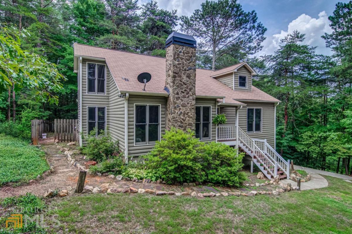 Don't miss this serene country retreat! Updated interiors, upgraded lighting & ceiling fans throughout. Beautiful stone fireplace accents the family room. Eat-in kitchen features white cabinets, granite counters, & stainless appliances. Separate dining room. Primary bedroom suite on main floor, features dual vanities plus separate shower & soaking tub. Two more spacious bedrooms & a full bath upstairs. Laundry & powder room on main. Relaxing screened deck overlooks private, wooded, fenced backyard. Unfinished basement offers storage, workshop space, or room to expand. Outbuilding with electricity makes a great man cave or she shed. Additional workshop or garage across the driveway. Both outbuildings have their own driveway. McKenzie Lane wraps around the property, giving you lots of privacy. Transferable AHS home warranty. Agent related to seller.