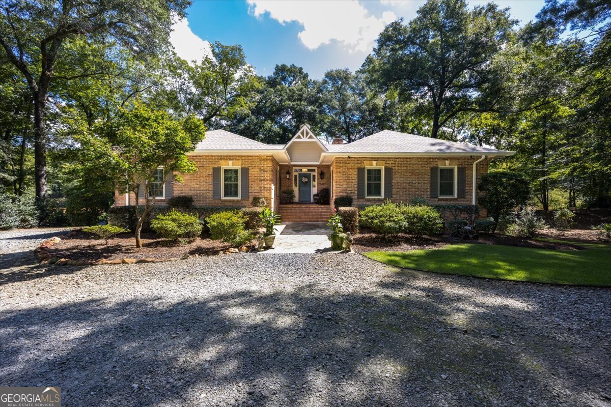 Come. See. Imagine. From the gated front entry to the banks of the Ocmulgee River, you will love it. The manicured grounds, trees, flowers, outdoor spaces and the private boat ramp, reflect a perfect place to call home. The home has been completely remodeled including all new triple pane windows. The gourmet kitchen is well designed and open to the family room with large eat-in island and gorgeous granite countertops. All appliances remain include refrigerator, one yr old dishwasher, microwave, gas 4 burner stove with griddle and electric oven, French door microwave/convection wall oven. Family room has a view of the water, opens to a screened porch, also includes a focal point fireplace, built-in cabinetry and 11.5-foot ceiling. Don't miss the remote-controlled ceiling blinds. Two spare bedrooms on main level with new Jack N Jill bath. Primary bedroom has massive window for view of the water and beautiful grounds, has access to the screened porch. Primary bathroom with walk-in steam shower, amazing counter tops on double vanity. Walk in closet in PBR. There is also a flex room that can be used as an office, playroom, den, large laundry room, pet room, inside storage area, But wait...the finished basement with exterior/interior access is gorgeous and practical. Basement includes 2 bedrooms, 1 full Jack N Jill bathroom, dining area, full living area, pool table included. Walk the path to the water, to the boat ramp or to the large deck. Oversized, detached 3 car garage and matching storage building completes this beautiful full brick masterpiece. Inspection and appraisal in hand. HOA is $250 a year, community garden space available, community security lighting. It is perfect.