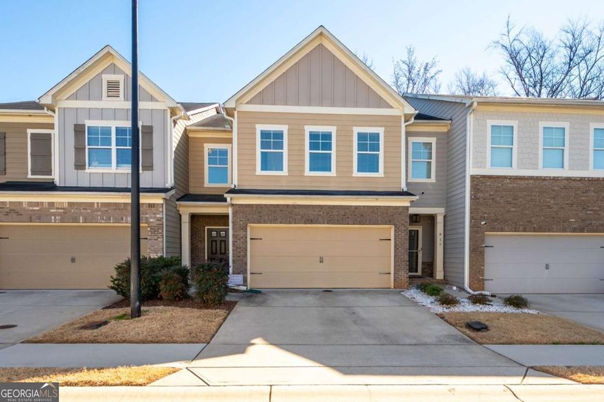Step into the comfort and style. This beautifully appointed 3 BR/2.5 BA townhome in Marietta is ready for it's new owner. Sellers can CLOSE QUICKLY. The open-concept floorplan and modern amenities create the perfect setting for relaxation and entertainment. The main level welcomes you with gleaming hardwood floors that extend throughout. The living room, centered around a striking gas fireplace, provides a warm, inviting atmosphere for gatherings or quiet evenings at home. Adjacent to the living area, the eat-in kitchen features GRANITE countertops, stainless steel gas appliances, and a walk-in pantry. The kitchen opens to a charming deck offering PRIVATE serene backyard views. A convenient half bath on the main floor adds functionality. Upstairs, the spacious primary bedroom serves as a private RETREAT, complete with a sitting area, stylish accent wall, and tray ceiling. The large walk-in closet provides ample storage, while the ensuite bathroom boasts a double vanity, separate shower, and bathtub. The home's bathrooms were UPDATED with new vanities and fixtures last year. Two additional large bedrooms feature spacious closets and share a well-appointed full bathroom. The laundry room, conveniently located upstairs, ensures easy access. This townhome also includes a two-car garage, providing plenty of space for vehicles and additional storage. Located close to local amenities and offers a blend of modern living and a convenient location, making it an ideal choice for anyone looking to live in Marietta.
