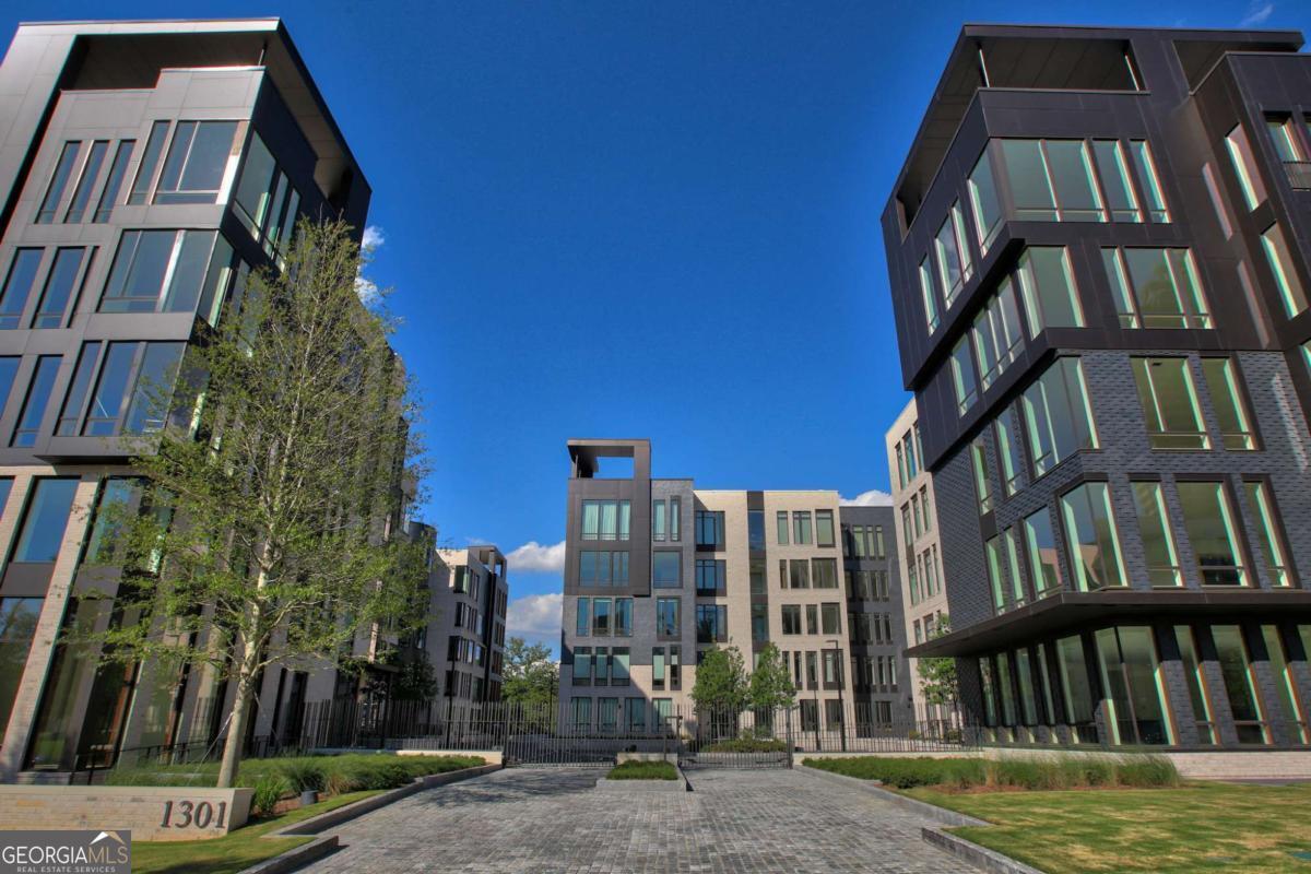 Located at the intersection of culture and green space, this 2-bedroom, 2.5-bath residence at One Museum Place places you in the heart of Ansley Park in Midtown-just steps from the High Museum and a close proximity to Piedmont Park, the Atlanta Beltline & Colony Square. Thoughtfully designed with 10-foot ceilings, clean architectural lines, and expansive windows, the home offers a balance of modern design and everyday comfort. The kitchen is designed for both cooking and gathering, featuring Gaggenau appliances, custom tilework, and ample storage. Just beyond, a private covered lanai extends the living space outdoors with treetop and city vistas. The primary suite serves as a private retreat with two walk-in closets and a spa-inspired bath complete with dual vanities, soaking tub, and walk-in shower. A flexible den and a secure, oversized 2-car garage with direct building entry add to the home's everyday ease. Residents of One Museum Place enjoy concierge service, a well-appointed fitness center, guest suite, and club room. With its premier location, this home offers an unmatched opportunity to enjoy elevated living in one of Atlanta's most sought-after neighborhoods.