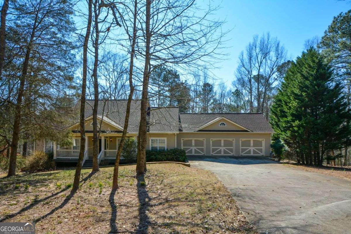 Tucked away on 3 private acres, this 4-bedroom, 2.5-bathroom home offers the perfect blend of peace, space, and comfort. From the moment you arrive, you'll feel the charm, starting with a long driveway and plenty of privacy. Inside, the spacious kitchen is ready for gatherings, with room to cook, connect, and enjoy a cozy breakfast nook. The large living room is perfect for relaxing or hosting, and there's a formal dining room for when you want something a little more special. A gas log fireplace adds warmth and character. Step out to the wide front porch or unwind in the screened sunroom that looks out over the quiet yard-there's no shortage of places to kick back and enjoy the outdoors. The 2,200 sq ft basement has its own fireplace and is already stubbed and plumbed-giving you a head start on creating the space you've been dreaming of. A 3-car garage offers plenty of storage and parking, and built-in speed bumps on the driveway add peace of mind. Just minutes from the interstate, shopping, and dining, you'll enjoy the best of both worlds: privacy and convenience. This home has been thoughtfully designed for everyday comfort and a touch of timeless style.