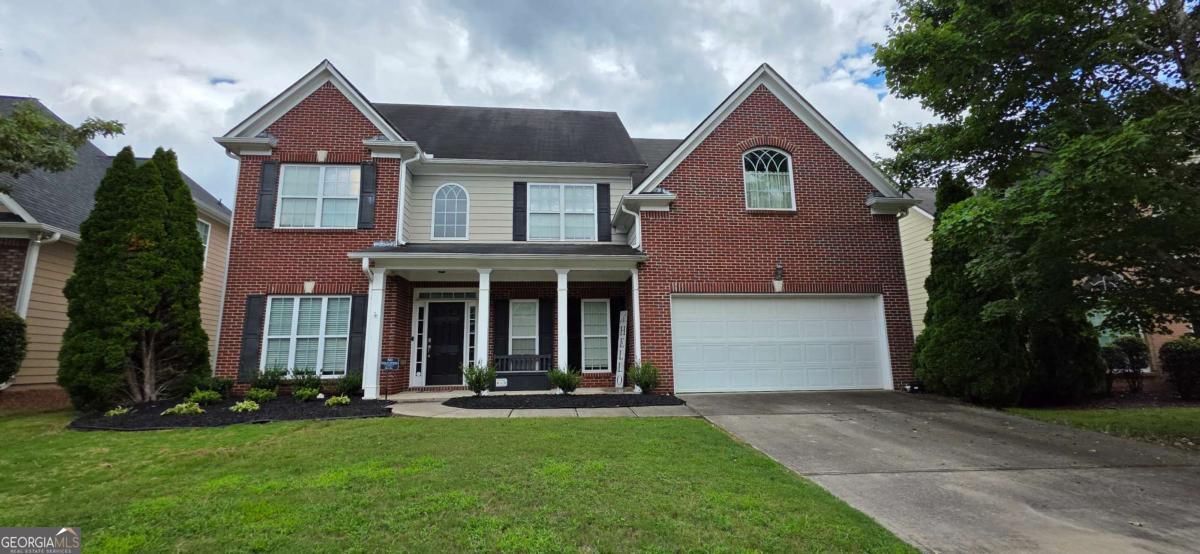 Discover move-in ready elegance in this stunning 4bedroom, 3 bath brick-front home located in the desirable Vinings Vintage community! The charming front porch sets the tone, leading into a sun-filled open floor plan with gleaming hardwoods, a flexible formal living/office, and a dining room that flows seamlessly into the dramatic two-story great room with soaring ceilings, abundant natural light, and a cozy brick fireplace. The chef's kitchen is designed to impress with abundant counter space, modern finishes, and a breakfast nook overlooking the level, fenced backyard perfect for entertaining, family gatherings, or enjoying peaceful mornings with coffee. A main floor guest bedroom offers convenience and privacy, while upstairs the expansive owner's suite is a true retreat with tray ceilings, a versatile sitting room, double walk-in closets, and a spa-like bath featuring dual vanities, soaking tub, and glass-enclosed shower. Spacious secondary bedrooms and a full bath complete the upstairs. Step outside to enjoy a private backyard oasis with a large patio ideal for grilling, play, or quiet evenings under the stars. Neighborhood amenities include a pool, tennis courts, and clubhouse, enhancing the community's charm and livability. All of this just minutes from I-285, Veterans Memorial Highway, and endless shopping and dining options. This home delivers the perfect balance of space, style, and convenience in a vibrant community setting.