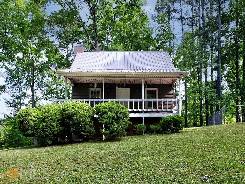Come home to this country charmer nestled on private acreage! The long winding driveway leads to the serene acreage and cape cod home. Rocking chair front porch leads to great room with wood burning stove adjacent to kitchen. Primary bedroom and bath are on the main level. Upstairs is a large secondary bedroom and full bath. Close to shopping and restaurants, this home offers country living at its' best.