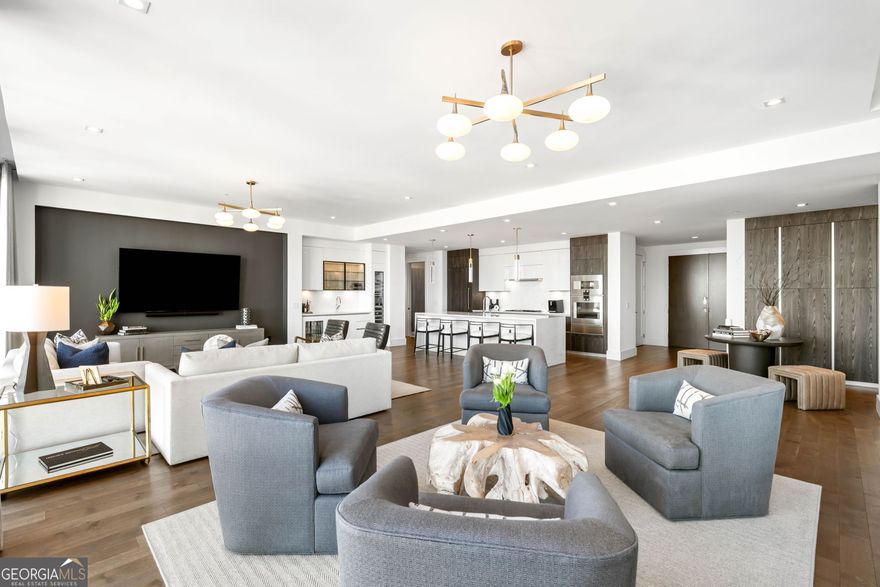 Welcome to this 3 bedroom, 3.5 bathroom, end unit located at Buckhead's iconic boutique luxury condominium, The Charles. This floor plan is arguably the most popular based on layout, size (3,800+sf), and indoor/outdoor living spaces - masterfully designed for entertaining. The well-appointed kitchen and wet bar feature quartz countertops with waterfall island, Pedini cabinetry and Gaggenau appliances including refrigerator, convection oven, steam oven, warming drawer, wine tower, microwave, and dishwasher. A large butler pantry with sink and connecting laundry room provide additional storage. The grand living room allows plenty of natural light by way of floor-to-ceiling windows with sweeping views of the Buckhead skyline. Open the NanaWall door system to extend the living space onto a large, covered terrace complete with tiled floor, fireplace, and gas grill. A separate dining room that overlooks the terrace easily accommodates a dining room table for 6+. The thoughtful floor plan design maximizes both owner and guest privacy. The primary ensuite is located on the west wing of the residence offering west-facing sunset views and north-facing Buckhead views. The primary bath includes double vanities, a frameless glass shower, separate soaking tub, and water closet. An oversized custom walk-in closet completes the spacious primary ensuite bedroom. The two guest suites are located on the residence's east wing. The junior primary bedroom easily accommodates a king-sized bed and sitting area with views of the Buckhead skyline. The junior ensuite bathroom features double vanities, frameless glass shower, separate soaking tub, and a custom walk-in closet that rivals the primary. The second guest bedroom accommodates a queen-sized bed and offers Buckhead skyline views, full bathroom, and custom walk-in closet. Ten-foot ceilings, hardwood floors, Circa and recessed lighting, and automatic window shades throughout. The residence includes three parking spaces and a temperature-controlled storage unit. The Charles' amenity level is the heartbeat of the building and features a club room, guest suite, stand-alone fitness center, dog walk, outdoor seating with fire pits, and infinity-edge style pool. Additional amenities include a 24-hour concierge and valet parking. Close to restaurants, shopping, and all Buckhead has to offer!