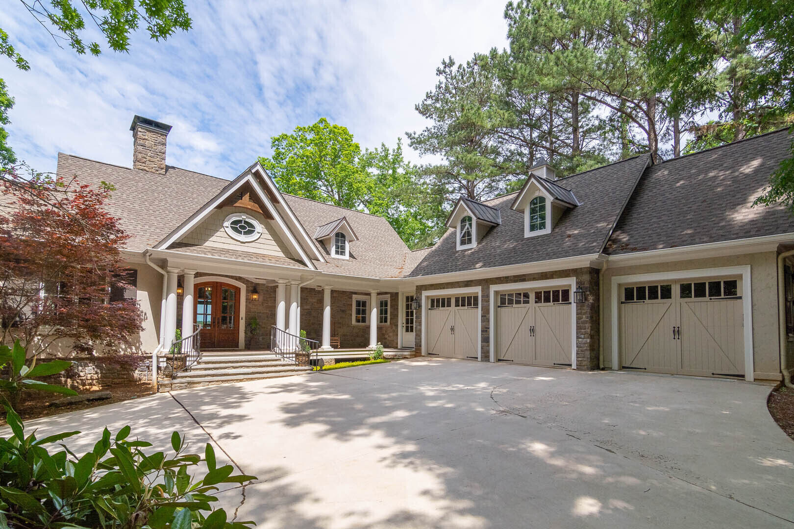 "THIS CUSTOM HOME PERFECTLY DEFINES A DREAM LAKE HOUSE WITH AN UNPARALLELED SETTING FEATURING JACK NICKLAUS GOLF COURSE AND MAJESTIC LAKE OCONEE AT YOUR BACKYARD" If you've ever dreamed of waking up to the fantastic views of a golf course and lake, this is it. Offering the best of both worlds, this home is perfectly situated on a waterfront, double lot right next to the strikingly beautiful hole #11 of the Jack Nicklaus Great Waters Course. Rarely does a property become available with this unique setting, steps from a Nicklaus premier golf hole and your own private lake dock. Lake views & spectacular sunsets can be viewed from almost every room of the house. Enjoy the afternoon from your outdoor kitchen watching the golfers or boaters, or playing one of the premiere holes of Great Waters course, right in your backyard. Located within walking distance to Great Waters clubhouse, golf shop, pool, playground, Waterside pub and tennis courts. This home has been completely renovated top to bottom under the guidance of renowned architect; Barry H. Light. Timeless luxury interiors are exquisitely showcased throughout this home's fine finishes. The main level Master bedroom features incredible lake views, vaulted ceiling and two separate extra large closets. The ensuite master bathroom has private access to the main level laundry room. There is an additional main level bedroom featuring ensuite bath and is perfectly situated to allow privacy for guests or family members. The kitchen has lake views, and is open to dining and great room. Additional living space on the main level, known as "The Lake Room" features vaulted ceiling, built in cabinets, mounted TV, custom wet bar and a 1300 bottle wine cellar. Lower level features three additional bedrooms all with private bathrooms, a large entertainment area, a recreation area with built in wet bar and an additional laundry room. Main level outdoor living includes screened porch with wood burning fire place, infra-red heaters, a sun deck with covered access to the outdoor gourmet kitchen. Lower level outdoor living space is covered and has walk out access to back lawn and lake front. Lake front has natural stone firepit, arbor over patio, max dock with boat lift and jet ski lift. Extra large three car garage has space above that can be finished if needed. All mounted TV's and Sonos system remain. This home has been immaculately maintained and is move in ready. Golf membership is available.
