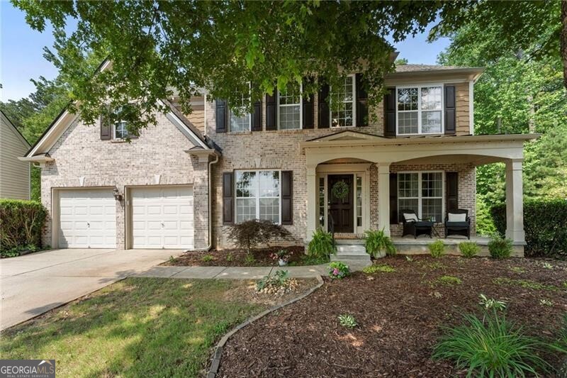 This stunning, six-bedroom, three-and-a-half bath gem in Avonley Creek has been updated to perfection and delivers the perfect blend of modern style and functional design. As you approach, a charming front porch sets the tone - ideal for morning coffee or evening chats. Step into the bright two-story foyer and discover a flowing open floor plan with bright, neutral paint and hardwood floors throughout the main level and extending into the upstairs hall and primary bedroom. The heart of the home is the fully renovated, entertainer's kitchen complete with soft gray cabinetry, quartz countertops and backsplash, a prep island with counter seating, stainless steel appliances (including a wine cooler), and a walk-in pantry. The sunny breakfast room opens to the two-story living room, where a cozy fireplace invites gatherings and a dramatic wall of windows frames peaceful wooded views. Step outside to soak up some natural beauty on the newly refinished deck-the perfect setting for alfresco dining, quiet mornings, or sunset cocktails overlooking the fenced backyard with raised garden beds. The main level also offers a spacious dining room and a versatile sitting room, as well as a dedicated office/playroom with French doors and a stylish powder room. A hardwood staircase with premium iron balusters leads to the upper level, where you'll find a tranquil primary suite with a trey ceiling and an oversized walk-in closet. The fully renovated, spa-inspired primary bath features dual vanities, a soaking tub, and an oversized frameless glass shower. Three generous secondary bedrooms, a hall bath, and a convenient upper-level laundry room complete this level. The fully finished daylight terrace level offers endless flexibility for living, entertaining or rental potential! With two expansive entertainment/living spaces, a kitchenette, two bedroom/flex spaces, a full bath, unfinished storage and a private exterior entrance, you can accommodate a crowd or create the ideal space for guests or multi-generational living. All this in a quiet cul-de-sac just steps from the community playground and pool-and only minutes to Gary Pirkle Park (5 min), Downtown Sugar Hill (5 min), and Lake Lanier/Buford Dam Park (8 min). Whether you're hosting a crowd or enjoying peaceful moments with family, this home delivers the space, style, and location you've been searching for.