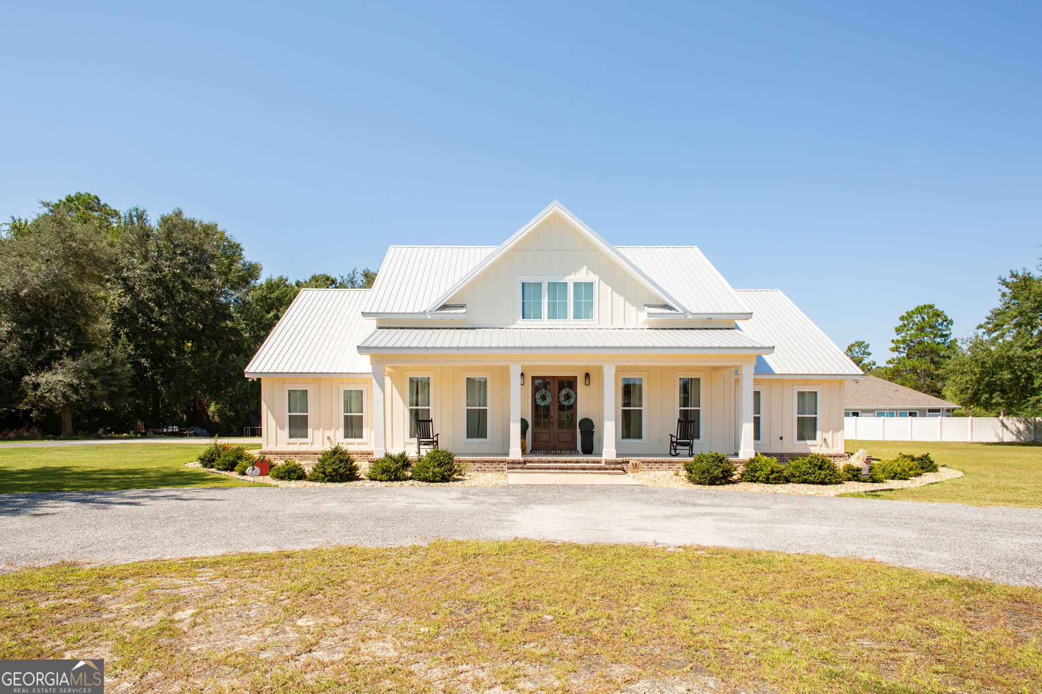 Modern Farmhouse on 1.55 Acres | 664 Saddle Circle, Waycross, GA $489,000 | 5 Bed 4.5 Bath 2,750 Heated Sq Ft 4,119 Under Roof Modern farmhouse charm meets thoughtful craftsmanship in this stunning corner-lot home on 1.55 acres. With 5 bedrooms, 4.5 baths, and 2,750 heated sq ft (4,119 under roof), this residence offers the perfect blend of open-concept living, custom finishes, and timeless design. Step inside to find quartz countertops in all baths and kitchen, a large island with prep sink, and a fireclay farmhouse sink as the centerpiece. Handmade dark walnut beams and two brick divider walls add warmth and character to the open living and kitchen space. Flooring throughout is 20 mil commercial-grade, styled as reclaimed oak in a rich walnut tone. The master suite features a Jack & Jill vanity, spacious walk-in closet, and walk-in shower. Upstairs, a 356 sq ft finished bonus room with full bath adds flexible living space, accessed by walnut-stained oak stairs with white risers. Every detail reflects quality-from solid-core bedroom doors and barn doors to the custom mudroom bench with hooks and storage. A tankless gas water heater, Galvalume roof with ZXL fasteners, and low $135 average power bill (Okefenokee Power) ensure long-term efficiency. Enjoy the outdoors with front and back porches, landscaped flower beds with weed matting and rock, and a paved circular driveway leading to the 3-car garage. Property Highlights: 4 Bedrooms | 4.5 Bathrooms 2,750 Heated Sq Ft | 4,119 Under Roof Open-Concept Modern Farmhouse Design Quartz Countertops + Fireclay Farmhouse Sink Handmade Beams & Brick Accent Walls Bonus Room with Full Bath Custom Mudroom Bench with Storage 3-Car Garage with Paved Circular Drive Tankless Gas Water Heater | Galvalume Roof 1.55 Acre Corner Lot This home truly has it all-space, modern farmhouse charm, energy efficiency, and custom features you won't find anywhere else. Don't miss your chance to own 664 Saddle Circle in Waycross, GA!