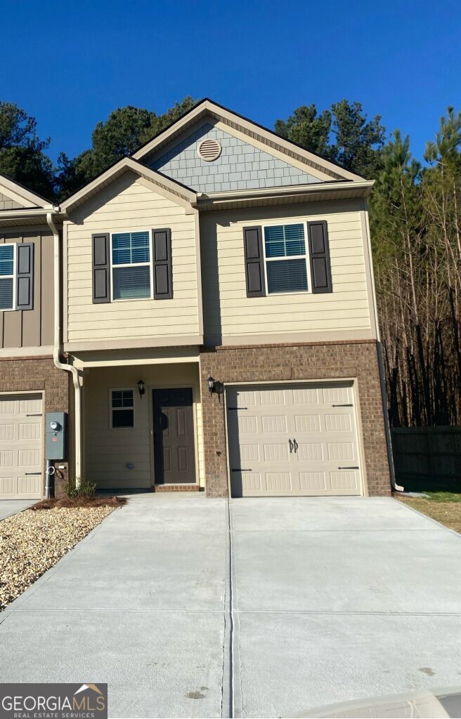 Welcome to this beautiful 3-bedroom, 2.5-bathroom townhome located in the desirable Oaks at Flat Shoals community. Built in 2021, this home is a thoughtfully designed living space that perfectly blends modern style and everyday comfort in a cul-de-sac. Step inside this end unit to find an open-concept main level featuring a spacious living area that flows seamlessly into the kitchen and dining space. The kitchen is a chef's delight with granite countertops, stainless steel appliances, an island with bar seating, and plenty of cabinet storage. Whether you're entertaining guests or preparing a cozy dinner at home, this space is sure to impress. Upstairs, the large primary suite includes a walk-in closet and a private bathroom with dual vanities and a separate tub and shower. Two additional bedrooms share a well-appointed full bathroom, providing flexible space for family, guests, or a home office. Enjoy morning coffee or weekend barbecues on your private patio, with just enough outdoor space to relax and unwind. Additional highlights include an attached one-car garage, laundry hookups, and access to a community playground and green space. Conveniently located near shopping, dining, and major highways, this home offers both accessibility and a quiet suburban setting. It's the perfect place to call home.