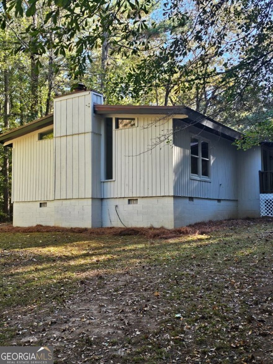 Country Living Near the City - Ola Area Beauty!   Escape to your own private retreat with this charming 4-bedroom, 2.5-bath home nestled on 4.81 acres of serene, wooded land in the highly sought-after Ola school district.  Step inside to find a spacious family room with a cozy fireplace and wood-burning stove, perfect for relaxing evenings. The bright sunroom brings the outdoors in, while the dining room and kitchen with a convenient window bar make entertaining easy and enjoyable.    Unwind in the master bedroom featuring its own fireplace, adding warmth and character to your private sanctuary.    Outside, enjoy the peaceful scenery from your wrap-around front porch or host gatherings on the back patio overlooking a fenced backyard. The property also includes a powered outbuilding with lights, ideal for a workshop, studio, or extra storage.    Experience the best of both worlds-quiet country living with city convenience just minutes away.     Location: Desired Ola Area   Bedrooms: 4   Bathrooms: 2.5   Acreage: 4.81 wooded acres   Features: Fireplaces in family room and master bedroom, wood-burning stove, sunroom, fenced yard, powered outbuilding, wrap-around porch   $10K seller concessions for repairs