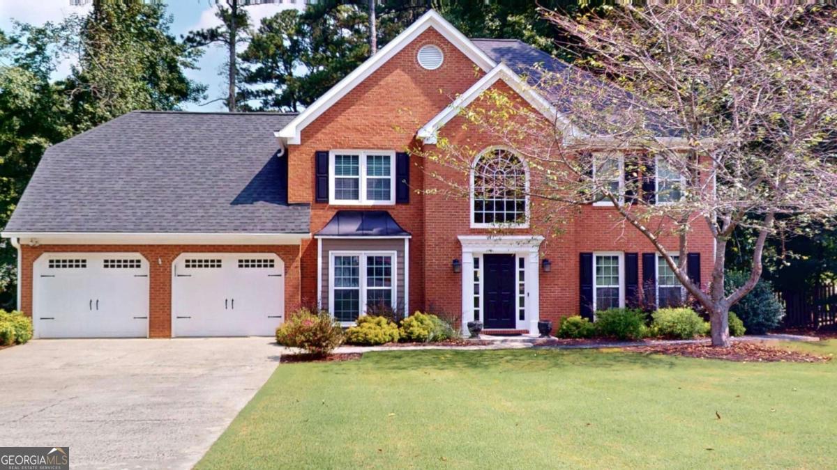 This brick-front two-story home offers spacious living with four bedrooms and two full baths upstairs, plus a convenient powder room on the main level. The large primary suite includes a bath with double vanities, a garden tub, separate shower, and a generous walk-in closet. The secondary bath features a separate vanity area and a water closet with a tub/shower combination. The main level has been recently renovated with engineered laminate flooring throughout. The kitchen includes granite countertops, a stainless steel sink with garbage disposal, and stainless steel appliances to include, dishwasher, electric range, and microwave. A large laundry room provides a washer, dryer, upper, and lower cabinets for storage, and hanging space. Living areas include a formal living room, dining room, and a spacious family room with brick fireplace. A vaulted media room enhances the home with a leathered granite bar, beverage cooler, wine cooler, sink, and a passthrough to the kitchen. The exterior features a level Zoysia lawn, a covered patio, and stone steps leading to a backyard gathering area with a fire pit. The private backyard offers plenty of space for outdoor enjoyment. This home combines thoughtful updates, functional design, and inviting indoor and outdoor spaces. Don't miss our 3D Virtual Tour for a full walk through of this beautiful property.