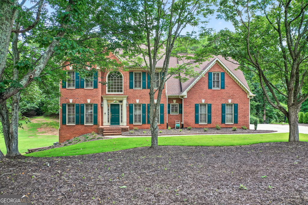Welcome to this beautifully maintained 4-bedroom, 2 Full Bath and 2 Half Bath home nestled in a sought after community with over 3,500 square feet of living space. This home offers both comfort and functionality for today's lifestyle. Step through a grand two-story foyer into an open-concept main floor featuring gleaming hardwood floors and plantation blinds throughout. The bright and airy kitchen flows seamlessly into the family room, where built-in bookcases frame a cozy fireplace. Just beyond is the oversized sunroom with cathedral ceiling and a wall of windows that invites natural light and access to the spacious back deck, perfect for entertaining. Upstairs, find four generously sized bedrooms, including a luxurious primary suite with double doors, a sitting area, custom built-ins and a fireplace perfect for relaxing. Glass double doors lead to the primary bath which boasts vaulted ceilings, double vanities, a whirlpool soaking tub, and dual walk-in closets. The finished terrace level offers versatile living space with it's own private entrance, an additional garage door ideal for a workshop or extra storage, and multiple rooms that can be used as an office, gym, playroom, or guest quarters. Enjoy a wealth of neighborhood amenities including a clubhouse, swimming pool, tennis courts, pickleball, playground, Haw Creek Park, Hiking Trail and a Mountain Bike Course. Located in the award winning Forsyth County school district and offering quick access to GA-400, Northside Hospital, shopping, dining and entertainment and just minutes away from Lake Lanier and the new Cumming City Center, this home truly has it all!
