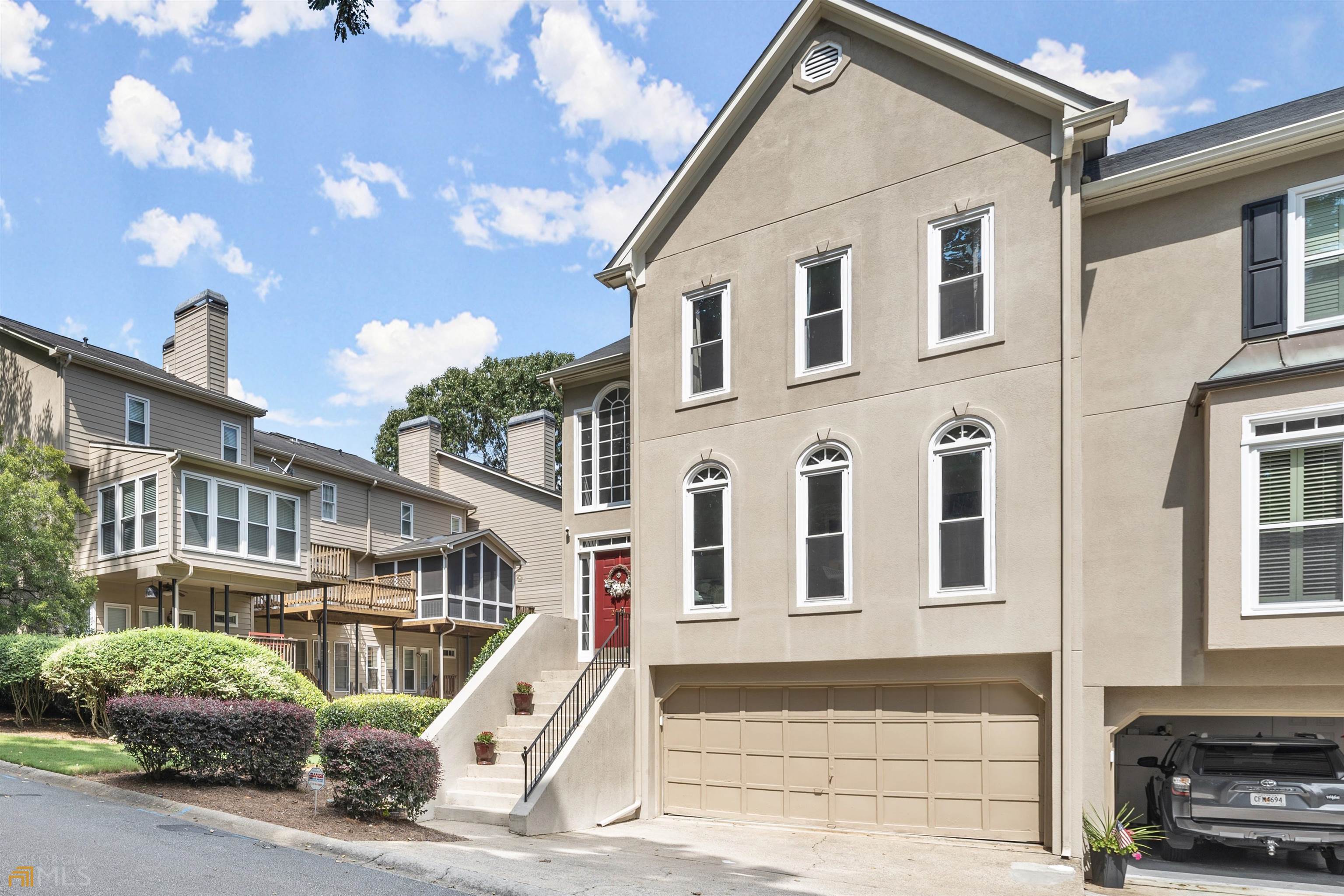Welcome to this gorgeous, John Wieland end-unit townhome located near all that Smyrna has to offer - The Battery at Truist Park, Smyrna Market Village, Silver Comet Trail, Midtown, Galleria, & Cumberland Mall. From the moment you enter the grand two-story foyer, you can feel the elegance. The beautiful, light-filled kitchen boasts stainless steel appliances, large breakfast bar/island, granite counter tops & timeless backsplash, and large eat-in area. Entertaining is easy with the open dining room that flows right into the stunning living room where form and function come together beautifully. The fabulous built-in bookcases offer storage and STYLE. Move through the double French doors into what is sure to become your favorite room in the home - the sunroom! The oversized primary bedroom is awe-inspiring with its tray ceiling and built-ins! Don’t miss the double closets! The grand, primary bathroom has magnificent, vaulted ceilings and is flooded with light. The secondary bedroom has its own en-suite bathroom! Laundry on the upper level offers great convenience. The lower level has a designated office/library/craft area adjoining what could be the third bedroom OR a bonus room (think media room, gym, game room… let your imagination run free!) complete with access to its own full bathroom!