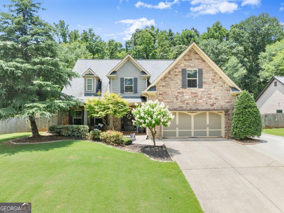 Gorgeous two-story home on a beautifully manicured 0.60-acre lot in sought-after Lake Vista Estates! Enjoy sunny days by the pool and relaxing evenings in the hot tub. This immaculate, model-perfect home features 4 spacious bedrooms, 3 full baths, a powder room, and a dramatic two-story foyer. The open floor plan offers the perfect blend of comfort and space, showcasing gleaming hardwood floors, elegant arched openings, and a formal dining room that flows into the bright kitchen with white cabinetry, granite counters, double ovens, stainless steel appliances, a breakfast bar, and butler's pantry. The vaulted great room centers around a cozy fireplace, while the main-level oversized primary suite impresses with a tray ceiling, double vanities, a custom walk-in closet, and spacious bath. Upstairs includes three additional bedrooms and two full baths-perfect for guests, home offices, or flexible living space. Outdoor living is a highlight with a hot tub, above-ground pool, three-tier deck, and covered patio-ideal for entertaining or relaxing. The fenced yard includes a dog run/kennel and storage building. A two-car garage and extended driveway provide ample parking for 4+ vehicles. Walk to the community lake with kayaking, fishing, pavilion, playground, and playfield. Conveniently located near I-85, Athens, shopping, and dining.
