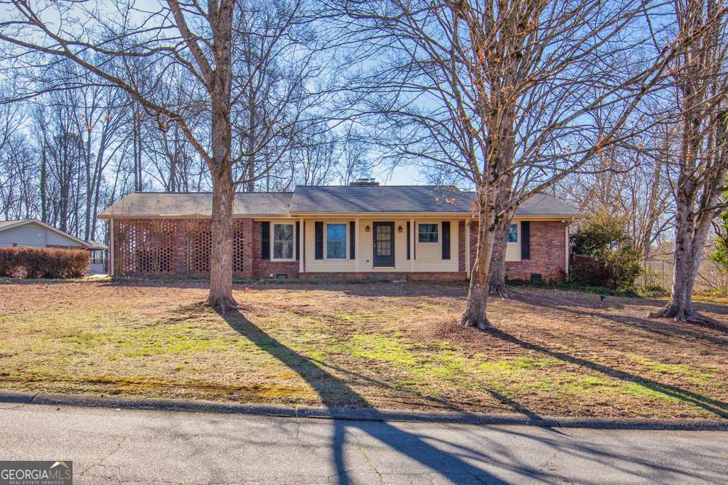 This charming ranch is situated on a bend towards a cul-de-sac in the sought after Piedmont Hills subdivision which resides in the Sprayberry High School District. This location enjoys minimal traffic in the community and itCOs about a 5 minute drive to I-575 and Barrett Pkwy. Excellent Location, convenient to dining, all sorts of shopping, grocery: Publix 0.3 miles, Kroger 2.5, Aldi 2.3, KSU, Town Center Mall (1.5 miles), Noonday Trail (walk, run and bike trail) 0.5, and Wellstar Kennestone Hospital, 4.2; all of this and much more are located within 5 miles. This location lives up to the benefits of a live, work, play, lifestyle. CGood BonesC, the craftsmanship and construction of homes built in the 1960s have a durable structure reputation. This unique 4-bedroom, -3 bathroom home is moderately sized yet is compartmentalized for maximum utility to suit a variety of buyers. Enter the galley style kitchen from the two-car carport; makes unloading groceries easy. The laundry/storage area is on one end of the kitchen and on the opposite side is a dinette area that opens into the family room. Your enclosed serene sunroom for relaxing with beverage and a good book is accessible from the family room. Three bedrooms, including one of two primary bedrooms are located down the hallway from the family room; there is a full bath located in that hallway. There is a living area just off the family room that can be used for the traditional or creative mindset. The flooring in the main living areas are hardwood. There is a private enclosed patio that overlooks a fully fenced backyard, ideal for outdoor activities. The spacious second primary bedroom is accessible from the family room and sits on the back side of the home. It features a modern bathroom and tiny kitchenette. This area, with its own access from outside would be perfect for a mother-in-law suite or space for short term/long term rentals. This meticulously maintained, move-in ready residence has an HVAC system that was serviced in October 2024, a roof that was replaced in 2020 and energy efficient double pane windows. Schedule your tour today and experience the comfort and convenience this property offers! This home is located in a community with no HOA, no fees or rental restrictionsCooffering the ultimate in convenience and flexibility.