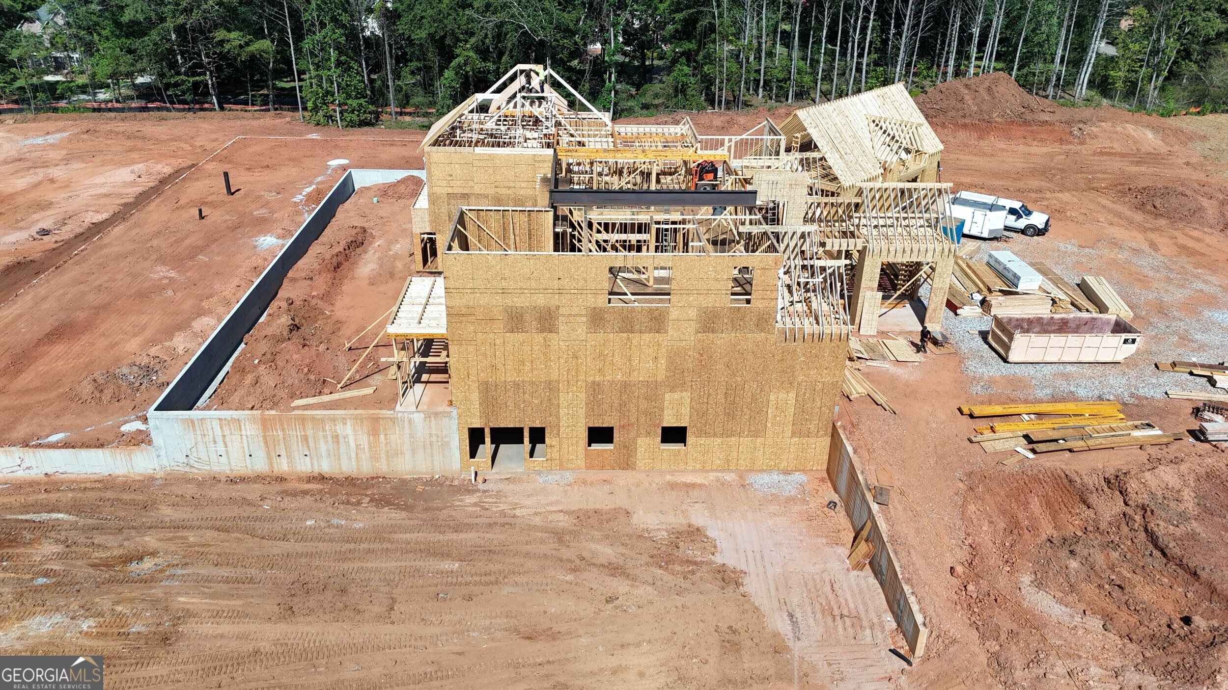 Set on over 12 acres in the heart of Milton, this private gated estate offers a rare blend of luxury, lifestyle, and land. Currently under construction by award-winning Loudermilk Homes, this custom-designed 11,000+ square foot residence features 5 bedrooms, 6.5 bathrooms, and a layout that brings together refined architecture with relaxed, everyday living in one of Georgia's most sought-after communities. This thoughtfully planned floor plan balances grand entertaining and personal retreat, beginning with a main-level primary suite that serves as a serene escape featuring a spa-style bath with dual oversized dressing rooms, and direct access to a covered terrace overlooking the resort-style pool and expansive grounds. At the heart of the home, a chef-inspired kitchen with double islands, a separate prep kitchen, walk-in pantry, and top-of-the-line Wolf and Sub-Zero appliances connects seamlessly to the living and dining areas, combining function and elegance in equal measure. The terrace level expands the experience with a full bar, poker room, fitness space, and multiple finished storage areas, while a state-of-the-art low voltage system integrates whole-house audio, home advanced security, and future-ready smart home capabilities. Upstairs features additional spacious bedroom suites with walk-in closets and en-suite baths, along with elevator-ready framing for long-term convenience. Expansive covered patios blur the line between indoor and outdoor living, with a custom pool perfectly positioned to capture the natural beauty of the landscape. A poured pad is already in place, offering future potential for a guest house, car barn, pool house, or equestrian facilities-allowing the property to evolve with your vision. From the moment you pass through the gates, the sense of arrival is undeniable-this is a home that lives as beautifully as it entertains. Whether you're hosting large gatherings or enjoying quiet evenings under the stars, every element has been curated with intention. Just minutes from top-ranked schools, local dining, and scenic parks, and less than an hour from both Buckhead and Hartsfield-Jackson Atlanta International Airport, this rare offering captures the essence of Milton living: elegant, timeless, and deeply connected to both community and land.