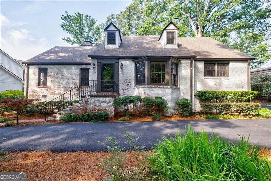 Gorgeously All Brick Traditional Home with Classic Charm in Prime Dunwoody Location! Completely renovated from top to bottom, this home blends timeless character with modern updates-and is just steps from Vanderlyn Elementary, Dunwoody High School, the JCC, and nearby places of worship. Originally built in 1945 in Buckhead and relocated to its current lot, the home retains its original charm with details like stained glass accents and classic built-ins, while offering all the benefits of a modern remodel. Inside, you'll find a sun-drenched sunroom, an spacious dining room, and beautifully renovated kitchen and baths plus new lighting, and fixtures - and hardwoods throughout. The main level features two bedrooms and a beautifully updated bath with built-in storage. French doors from the sizeable great room open into the bright sunroom, creating an easy flow for both everyday living and entertaining. Possible option is to open the 2 bedrooms for a primary on main. Upstairs is a large primary suite with a renovated bath, loft area for office or sitting area + an additional bedroom which could be converted into a large walk-in closet! Enjoy morning coffee or evening gatherings on the deck overlooking the flat, fenced walkout backyard. Additional upgrades include a brand-new circular driveway with parking area offers ease and convenience! This is perfect for those seeking move-in ready with walkability, charm & character. The basement offers additional storage space. Located within easy walking distance to grocery stores, restaurants, CVS, Crema Gourmet Coffee, and just minutes to Dunwoody Village, GA-400, and the Perimeter area!