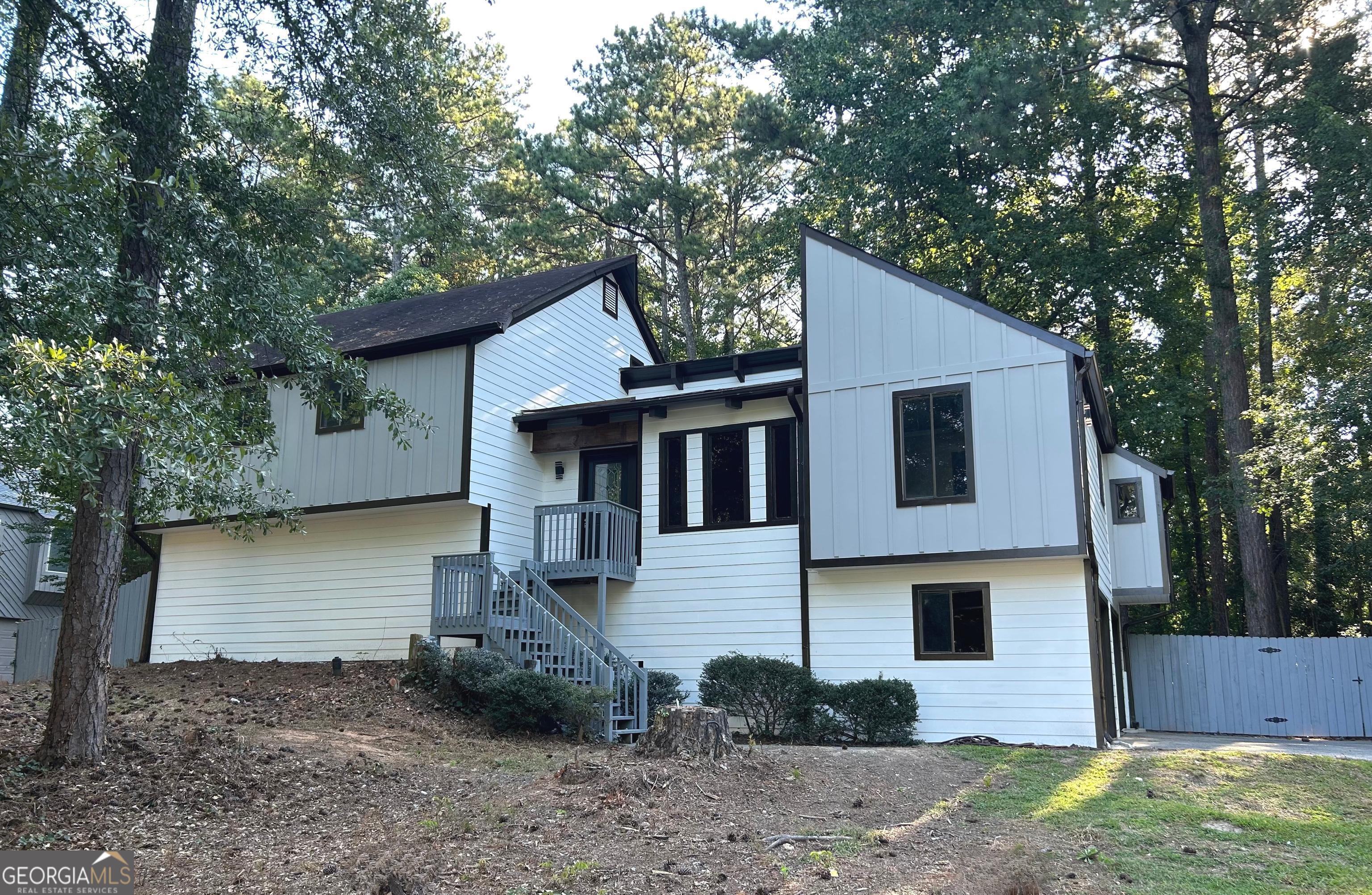 Available 9/4/25. Nearly 3000 sq. ft. Spacious 5 bed, 3 full bath home in the Pope High School district. Newly remodeled contemporary home. New siding, new lvp flooring and fresh paint throughout. Main level features open floor plan with exposed beams, solid surface kitchen countertops, eat-in kitchen with island, separate dining room and family room with fireplace. Upper level has spacious master suite with balcony, two nice sized secondary bedrooms and a shared bath. There are two additional daylight bedrooms, full bath and exterior entrance in lower level. Large fenced back yard. Pets welcome with additional pet fees. Hurry, won't last long. Call agent for easy showing.