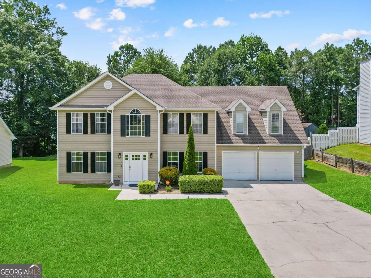 Welcome to 1793 Harmony Trace in Lithonia, your new home! A stately 4 bedroom, 2.5 bath home with over 2,700 square feet of living space. From the moment you pull up, the home commands attention with its well-manicured yard and impressive curb appeal, the type of property that immediately feels like home. Step inside and you are greeted by a soaring two story foyer anchored by a cascading split staircase that sets a tone of elegance and flow throughout the property. To each side of the entry are separate formal living and dining spaces that provide flexibility for entertaining or quiet gatherings. The kitchen has been fully upgraded with sleek countertops, a stylish backsplash, new stainless steel appliances, a deep basin sink, and modern light fixtures, all complemented by upgraded flooring on the main level. Upstairs, the owner's suite is expansive with a private sitting area filled with natural light, easily accommodating a full king set with space to spare. The ensuite bath has been completely reimagined into a true spa retreat featuring a floating double vanity with a heated mirror, an oversized walk-in shower with a freestanding tub, a colorful electric fireplace, modern lighting, a mounted TV, and an expansive walk-in closet. The secondary bedrooms are generously sized and offer both privacy and comfort. This home has been completely reimagined & is eligible Down Payment Assistance, $10,000 grant, & more. Contact the listing agent for details The location adds even more value, with Stone Mountain Park, Arabia Mountain National Heritage Area, and Panola Mountain State Park just minutes away for endless recreation and hiking options. Stonecrest Mall, dining, and entertainment are right around the corner, and with easy access to I-20 you are within 30 minutes of Hartsfield-Jackson International Airport and downtown Atlanta. With no HOA restrictions, this property is versatile enough to meet a variety of buyer needs: it is the home a first time buyer envisions as their starting point, a legacy property for families seeking long-term stability, or the perfect retirement and investment opportunity with Airbnb potential. Best of all, every picture you see reflects the home in its true form - the property has not been virtually staged, allowing you to experience its authentic beauty and character. 1793 Harmony Trace offers top tier modern luxury and lifestyle convenience at a price point that makes sense for every budget, and it is ready for its next owner to create lasting memories.