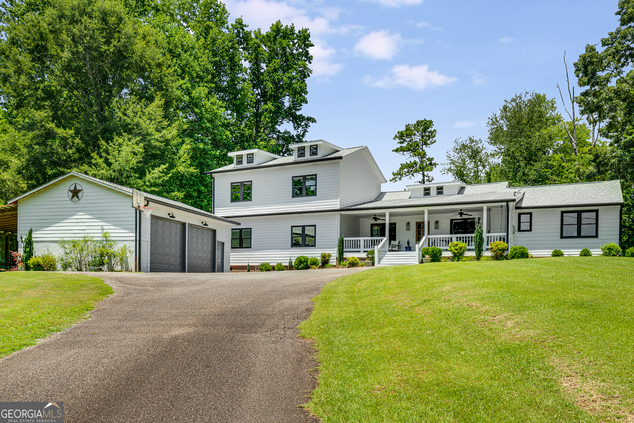 || 1.21 ACRES OF PRIVATE, NON-HOA LAND || || FULLY RENOVATED MODERN FARMHOUSE || || TWO PRIMARY SUITES + NEW ADDITION || || DESIGNER TOUCHES: QUARTZ COUNTERS, SHIPLAP, UPSCALE FIXTURES || || ROOM FOR POOL + COVERED RV PARKING || || AWARD-WINNING MILTON SCHOOLS || || MINUTES TO AVALON, DOWNTOWN ALPHARETTA & CRABAPPLE || ** What You'll See ** From the moment you turn onto the long private driveway, you'll notice the curb appeal-classic farmhouse lines, an inviting front porch, and professionally landscaped grounds. Step inside to a sun-soaked open layout featuring shiplap walls, custom paneling, and high-end finishes like quartz countertops and marble porcelain tile. French doors lead to a covered back porch overlooking your sprawling yard-ideal for a future pool. ** What You'll Hear ** Hear the laughter from family gatherings flowing through the open-concept kitchen and living spaces. Out back, the soft rustle of wind in the trees and chirping birds offer a peaceful soundtrack. Inside, enjoy the quiet hum of brand-new systems, double-pane windows, and modern insulation for a home that sounds as comfortable as it feels. ** What You'll Feel ** Feel grounded as you step onto real hardwood floors and into rooms thoughtfully designed to flow naturally. Whether you're sinking into a freestanding tub after a long day or prepping dinner with family in the light-filled chef's kitchen, this home encourages connection and comfort. From coffee on the front porch to playtime in the backyard, you'll feel right at home. ** What You'll Experience ** Every inch of this home has been updated for peace of mind: NEW roof, NEW HVAC, NEW windows, NEW plumbing fixtures, and a newly added upstairs suite with its own media/playroom and walk-in closet. With five bedrooms and four full baths, including dual primary suites, the home is perfect for multi-generational living. Located minutes from top-tier golf, parks, dining, and shopping-with award-winning schools and easy access to GA400-this is the smart choice for both lifestyle and long-term investment.