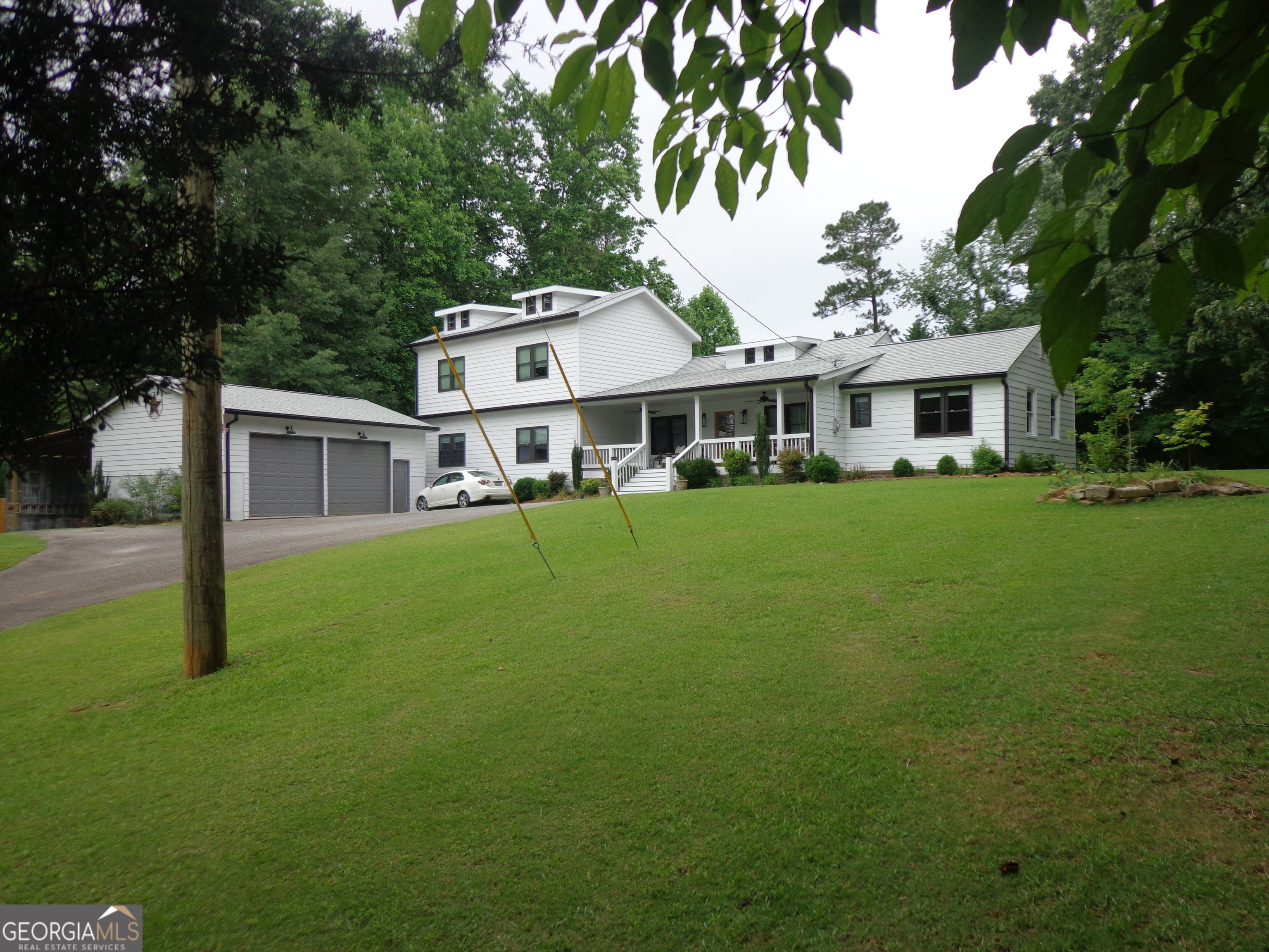 || FULLY RENOVATED || || ALL MAJOR SYSTEMS LESS THAN 7 YEARS OLD IN THE MAIN HOUSE AND A YEAR OLD IN THE NEW ADDITION || ||1400 SQ FT NEW ADDITION || || NEW ROOF || || NEW WINDOWS || || NEW HARDI SIDING || || NEW HARDWOODS + NEW BEDROOM CARPET || || NEWLY CONNECTED PUBLIC WATER + FUNCTIONAL WELL || || 1.21 PRIVATE, FENCED ACRES || || NO HOA + NO RENTAL RESTRICTIONS || ** What You'll See ** Drive down your 800-foot asphalt driveway and arrive at a beautifully updated home nestled on a LEVEL, LANDSCAPED 1.21 ACRE LOT. The entire property is FULLY FENCED, giving you peace of mind and privacy. Step onto the CHARMING FRONT PORCH or relax on the BACK DECK, both perfect for taking in the abundant wildlife and nature views. Inside, admire the BRAND NEW HARDWOODS, NEW CARPET IN BEDROOMS, and the expansive BONUS ROOM added in the new 1,400 sq ft addition. The OPEN-CONCEPT KITCHEN features GRANITE COUNTERS, INSULATED WINDOWS, and a large ISLAND WITH A VIEW TO THE FAMILY ROOM. Every detail feels fresh because EVERY SYSTEM IS NEW (7 YRS OR YOUNGER). ** What You'll Hear ** Listen to the soothing sounds of nature-the gentle rustle of wind through trees, the occasional chirp of birds, and the quiet stillness that only comes from a PEACEFUL, PRIVATE LOCATION with NO HOA and NO ROAD NOISE. It's quiet here. Safe. Peaceful. On cool evenings, enjoy the subtle hum of energy-efficient systems working in the background-all ENERGY STAR APPLIANCES, NEW HVAC, and a MODERN 200 AMP ELECTRICAL PANEL running efficiently. ** What You'll Feel ** Feel the warmth and comfort of a MASTER SUITE ON MAIN, plus a stunning NEW ADDITION designed for convenience and privacy. Soft plush carpeting in the bedrooms, smooth hardwood floors underfoot, and updated insulation all work together to create a home that feels solid, quiet, and welcoming. Whether working in the DETACHED OVERSIZED GARAGE, parking your RV under its covered space, or sipping coffee on the porch, you'll feel the freedom of space-physically and emotionally. ** What You'll Experience ** From the moment you arrive, you'll experience life without compromise: NO HOA, NO RENTAL RESTRICTIONS, and total freedom to live how you choose. You'll sense the ease of knowing ALL MAJOR SYSTEMS ARE UPDATED, the convenience of PUBLIC WATER plus a backup WELL HOUSE, and the satisfaction of moving into a SMOKE-FREE, PET-FREE HOME. The TRANSFERABLE HOME WARRANTY offers peace of mind, and the location-CLOSE TO EVERYTHING yet tucked away-gives you the best of both worlds. This is more than a home-it's a lifestyle upgrade.