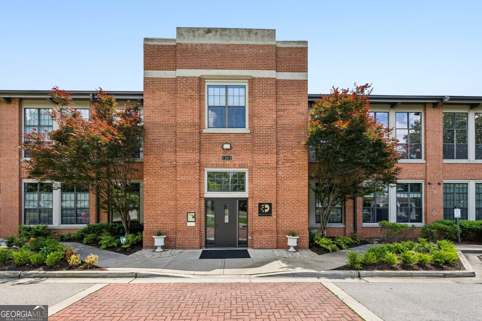 This is a Great loft with brick walls, great windows high ceilings and convenient Edgewood location. It is a short walk to the Edgewood Candler Park Marta and has an abundance of shops and restaurants within minutes. The Shoe Factory Lofts were a conversion in 2006 with soaring ceilings and a great open floorplan. It is an end unit, so it has two walls of windows in the living room and two beautifully bright bedrooms and two full baths. There are brick walls, hardwood floors, and lofty ceilings throughout. There is stepless entry so this would be ideal for handicapped people. It has a dining room, and a laundry closet with a washer and dryer that remain. All the kitchen appliances remain. There is one assigned deeded parking spot in a secure area under the Target, and quite a bit of parking in the private lot next to the unit. Also parking for guests is in front of the building and in the shopping center next to the Petco with stairs that lead up to the building. There is a storage room with a separate enclosure to keep your kayaks and bikes. This is a tightly managed association with a reasonable fee.