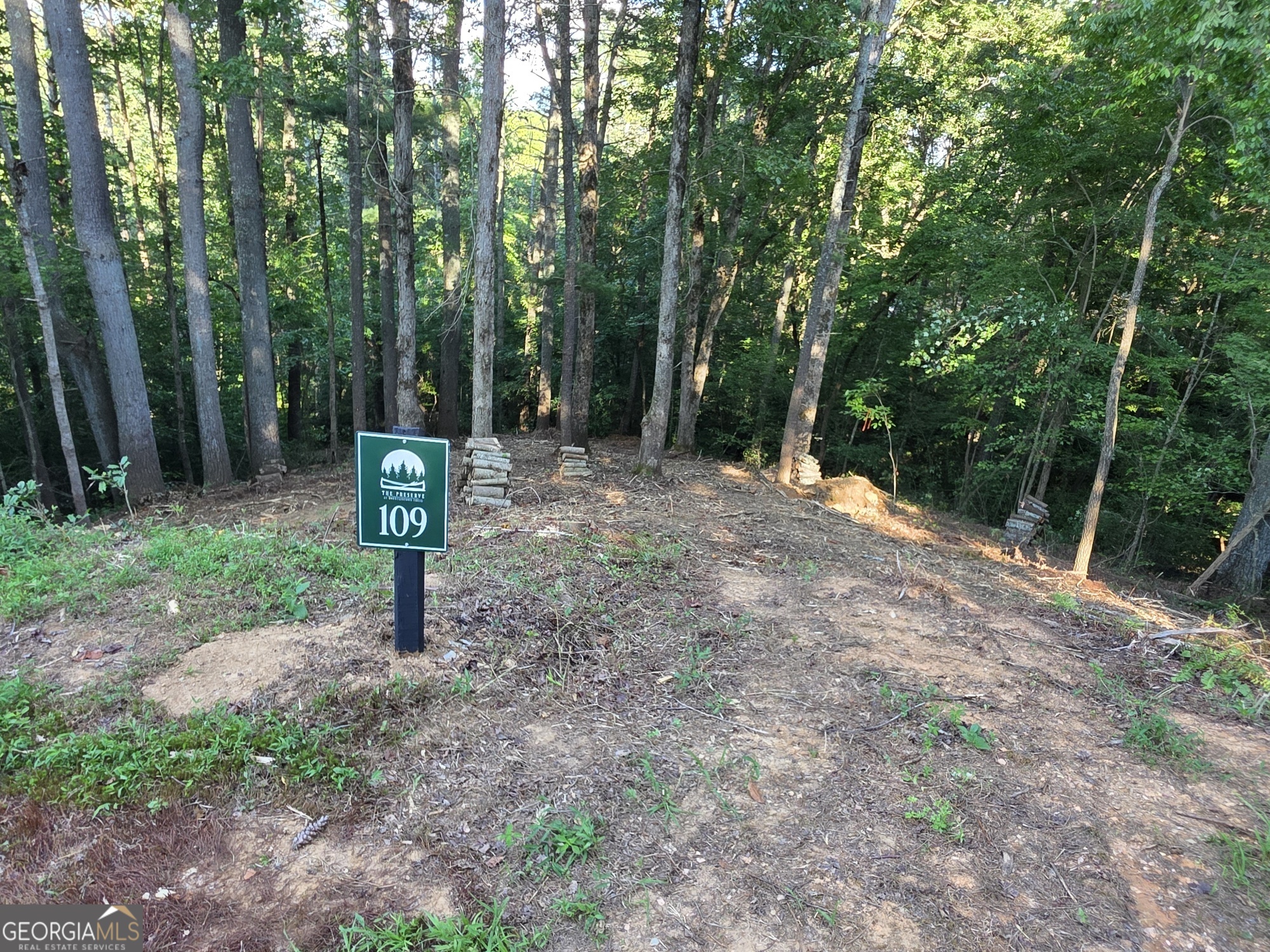 Escape the hustle and bustle of city life and discover your mountain retreat on this beautiful 2.37-acre private, wooded creekfront lot in the heart of the North Georgia Mountains. Tucked away in the scenic town of Ellijay-only 7 Miles from downtown-this lot offers a peaceful setting with an easy buildsite, making it perfect for your dream cabin or weekend getaway. Located in The Preserve at Mountaintown Creek, a gated community designed for nature lovers and outdoor enthusiasts, you'll enjoy top-notch amenities including a fully completed pool and pavilion, pickleball court, creekfront park, and a kayak/canoe launch offering access to a full mile of bold trout stream. With paved roads, underground utilities, and city water already in place, this property is ready for you to build and enjoy. Don't miss this rare opportunity to own creekfront land in one of North Georgia's most desirable mountain communities.