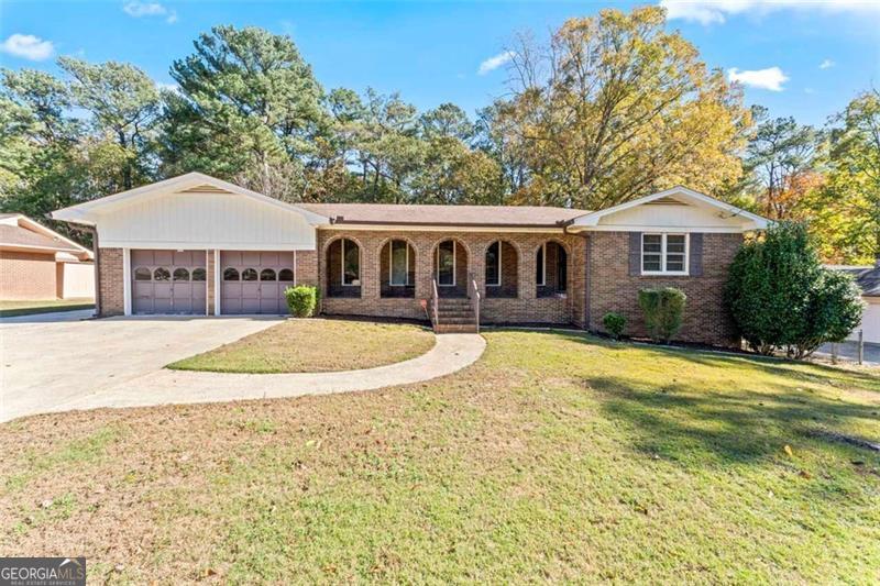 This well-maintained 4-sided brick home offers both comfort and style. Situated in a quiet neighborhood with no HOA, this property features a large front yard, perfect for outdoor relaxation, and a fully fenced-in backyard, ideal for family fun and pets. As you approach, you'll be captivated by the home's architecture, highlighted by elegant arches. The inside is equally impressive. You'll find beautiful hardwood floors, a spacious living room, a dining area, and modern kitchen with granite countertops and stainless steel appliances. The basement, almost entirely finished, offers a versatile space that can be customized to your needs. It includes a finished bathroom and an additional bedroom, providing endless possibilities. Outside, you'll discover a raised bed garden, perfect for gardening enthusiasts, and an outbuilding, ideal for additional storage. Enjoy the convenience of being close to the airport, downtown Atlanta, and numerous attractions and great restaurants. Don't miss this opportunity to own a beautiful home in a desirable location. Schedule your showing today!