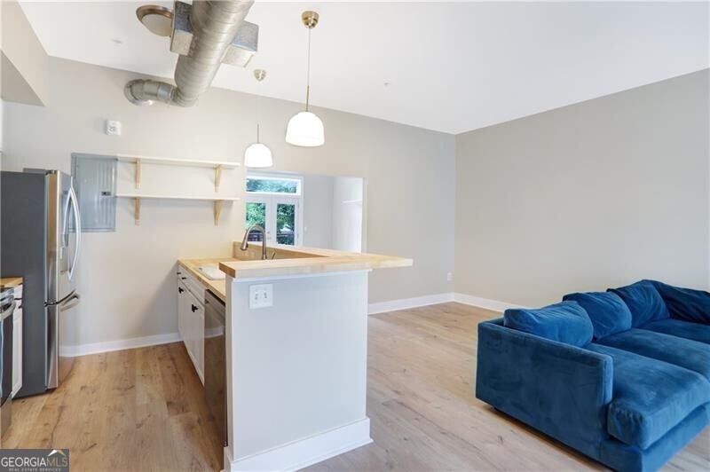 Welcome to elevated city living in this beautifully updated 1-bed, 1-bath condo nestled within the gated City Side Lofts complex-just minutes from lively Summerhill and downtown Atlanta. Step inside to discover soaring ceilings, brand new modern LVP flooring, fresh paint, and an open layout bathed in natural light. The kitchen delights with stainless steel appliances and a breakfast bar, while the updated bathroom features tasteful finishes and upgraded fixtures. Cozy comforts include in-unit laundry and a walk-in closet. Outdoors, enjoy a pool and courtyard mere steps from your front door. Secure, assigned parking, controlled access, and lush common areas deliver peace of mind and ease. Located in a walkable, transit-rich neighborhood, you're conveniently close to MARTA, I-75/85, I-20, and just ~15 minutes from ATL airport. Live just a stroll away from Publix, the BeltLine, Grant Park, and the booming Summerhill corridor-where vibrant local shops and new development continue to rise. Affordable, stylish, and ideally located-this condo is a standout value and a true must-see.