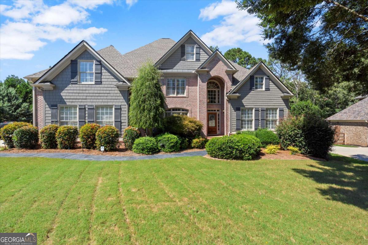 Welcome to this stunning 7-bedroom, 5.5-bathroom home boasting 6,401 sq ft of beautifully renovated living space in an exclusive golf community. Freshly painted throughout with refinished hardwood floors on the main and brand-new carpet upstairs, this home blends comfort and elegance. The updated kitchen features high-end appliances, while the renovated primary suite offers a spa-like bath and a custom closet. Secondary baths have been tastefully updated as well.The entertainer's basement includes a large bar, media room, workout space, and doggy door. Outdoors, enjoy a newly designed deck, a large gunite pool, hot tub, stacked stone fireplace, and turf lawn within a private fenced backyard. Additional highlights include a brand-new roof and a three-car garage with epoxy-sealed flooring. Living in Bridgemill means access to incredible amenities: an 18-hole championship golf course, 2-acre aquatic center with pools and splash pad, 25 lighted tennis courts, pickleball, fitness center, parks, playgrounds, and walking trails. Plus, enjoy the vibrant community with social events, dining, and activities for all ages.This home is truly move-in ready and designed for luxury living.