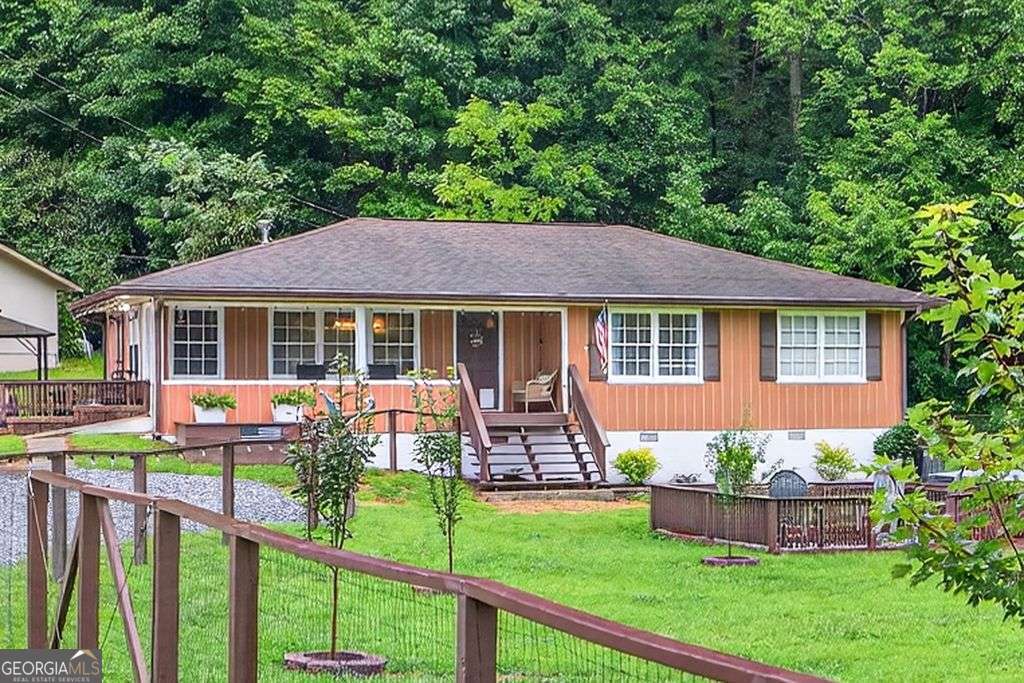 Welcome to 8 Taylor Rd, located in the heart of the picturesque town of Helen, GA. This beautifully updated home is perfect for those looking for a move-in ready property in a unique and charming location. The Chattahoochee river and parks are located just across the street. The amazing yard is fenced, landscaped and has two sheds for storage or hobbies. As you step inside this home, you'll immediately notice the tasteful updates that have been made to this home. The remodeled countertops, new fixtures, blinds, outlets, and chandelier create a modern and stylish feel throughout the home. The entire interior has been freshly repainted, giving the home a bright and welcoming ambiance. The town of Helen is known for its quaint German-themed architecture, making it a popular destination for tourists. This property is perfectly located to take advantage of all the town has to offer, with restaurants, shops, and activities just a short walk away. This property is a rare opportunity to own a move-in ready home in a prime location. Don't miss your chance to experience the unique charm of Helen, GA in this beautifully updated home. PERFECT for a great vacation home or potential short term rental.