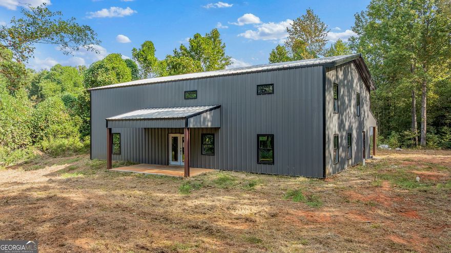 Under Construction Barndominium on 5.17 Acres in Banks County! Already equipped with plumbing and power, giving you a head start on building your dream home.This remarkable property offers the flexibility to be completed as a spacious 4,800 sq. ft. two-story home or finished according to the current 2,400 sq. ft. floor plan featuring 3 bedrooms and 3 full baths.Designed for open-concept living with soaring ceilings and a layout that adapts to your vision-whether you dream of a modern farmhouse, rustic retreat, or sleek industrial design, the possibilities are endless.Enjoy the perfect blend of privacy and convenience, ideally located near I-85, Commerce, and Gainesville. Create your custom dream estate and bring this Barndominium to life exactly the way you imagine it.