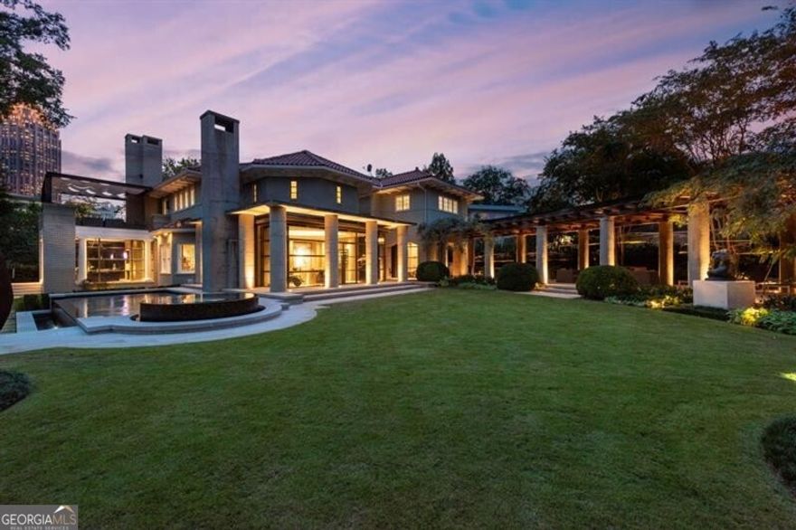 STUNNING TOTAL RENOVATION OF A MOST SPECIAL SOPHISTICATED ANSLEY PARK RESIDENCE ON A DOUBLE LOT WITH LOVELY CARRIAGE HOUSE.  A rare opportunity to own a gorgeous home done to perfection in Atlanta's most sought after intown neighborhood. Totally renovated by current resident - all new windows, roof replaced in 2023, all renovated bathrooms and kitchen, basement with gym that has a 7'5"X5'5" aquarium window into the pool, wine cellar and one and a half baths. Flat walk out yard with sculpture garden and views of downtown skyline. Magnificent heated saltwater pool with 2 underwater speakers. Rooftop terrace off of primary suite also with skyline views.  So many special details!! An art collectors delight with beautiful light filled interiors. Beautiful mature landscaping. This is an amazing opportunity for the most discerning buyer, not to be missed!!