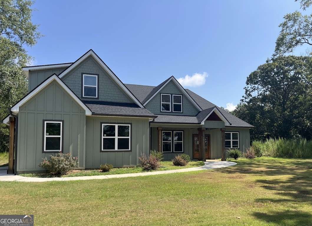 Practically new and perfectly designed! This stunning 5-bedroom, 3-bath home sits on 3.45 acres, offering the ideal blend of modern comfort and peaceful privacy. Built in 2022, the home features an open floor plan with gorgeous wood floors throughout and an inviting layout perfect for everyday living and entertaining. The heart of the home is a chef's dream kitchen-complete with a large island with seating, granite countertops, ample cabinet space, and a pot-filler faucet above the stovetop. A cozy keeping room/breakfast area adds additional space to gather. The main level includes a luxurious owner's suite with a spa-like bath featuring a separate soaking tub and oversized tiled shower, plus a custom walk-in closet with rich wood shelving. Two additional bedrooms and a full bath are also located on the main level. Upstairs, you'll find two more spacious bedrooms-one of which could easily serve as a bonus/media room-and a third full bath. Enjoy the cozy indoor fireplace or relax outdoors under the covered patio, which boasts a second fireplace-perfect for year-round enjoyment. An easy commute to Downtown Carrolton and West Georgia University, this home is a rare find with acreage, style, and space just minutes away from fun, shopping and entertainment.