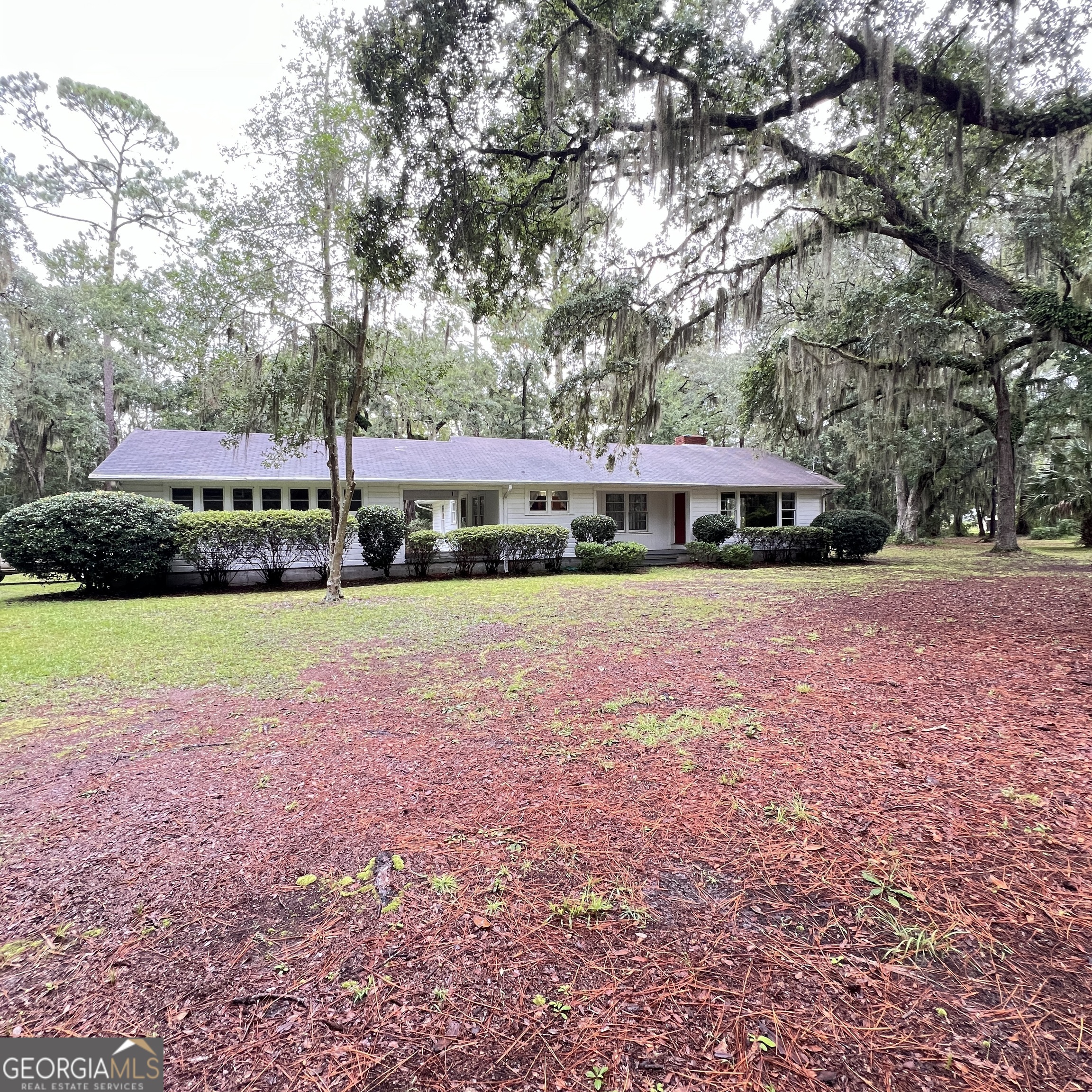 This one-of-a-kind, ultra-private marsh front estate has been in the same family since 1952. Spanning 9.92 deeded acres of oak-shaded uplands and 19.17 taxed acres of breathtaking marshland, it totals 29.09 taxed acres. The property boasts 755 feet of highway frontage on GA 303 and 414 feet of marsh frontage overlooking the South Brunswick River. It features a charming 3-bedroom, 1-bath 1,750-square-foot wood-frame ranch home built in 1958, with tongue-and-groove heart pine, wormy maple, and cypress paneling, hardwood floors, a 2-car garage, a fireplace, a breezeway, and a sunroom, though some maintenance is needed. Surrounded by a canal, salt marsh, a state highway, and just one neighbor, the privacy is unparalleled. Elevated land ensures no flooding from hurricane storm surges under current ownership. Zoned for forest agriculture, the property includes two water wells, two GA Power electric drops, and a security light. Additional structures include a three-vehicle metal pole barn, a single-car wood-frame garage, and a storage shed. Located just one mile from I-95 (Exit 29), it is 80 miles from Savannah, 70 miles from Jacksonville, and near essential amenities. Attractions include St. Simons Island, Jekyll Island, Cumberland Island, Historic Brunswick, Blythe Island Regional Park, and the Okefenokee Swamp. Coastal Georgia's charm is unmatched. The area's history traces back to 18th-century grants, with ties to figures like Captain Mark Carr, reflecting a rich heritage from colonial times through WWII and beyond. This gorgeous property offers stunning views of the South Brunswick River, connecting to the Turtle and Back Rivers for prime fishing and boating, and represents a rare opportunity to acquire a uniquely private, ideally located slice of premier marsh front land, unlike any other offering on the market. Showings are by appointment only. __________________________________________________________________________________________________