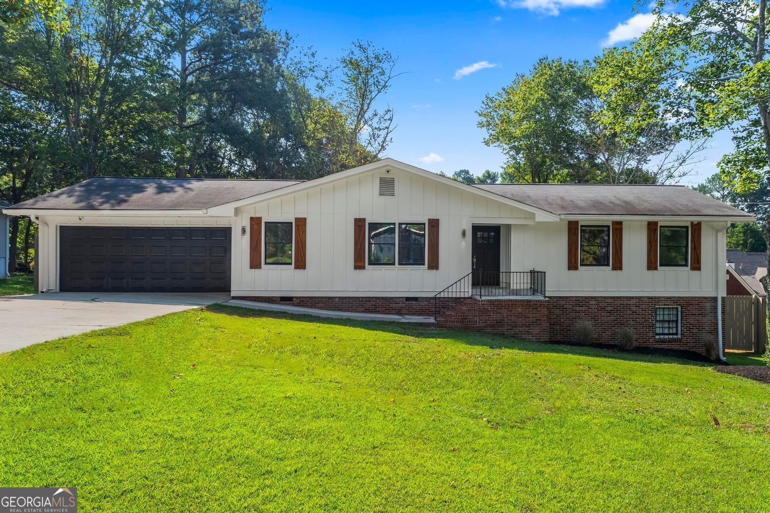 Fully renovated ranch in Lawrenceville with 3 bedrooms, 2 bathrooms, and an oversized bonus room across 2,034sq ft on the main level, plus 1,591sq ft of unfinished basement space with exterior door. The open floor plan includes a living room with wood-burning fireplace and abundant light, dining area, and gourmet kitchen with Shadow Storm marble countertops, oversized island, farmhouse sink, stainless appliances, and open shelving. The spacious primary suite features great natural light and a modern updated bath with walk-in marble shower and custom vanity. Two additional bedrooms share a beautifully updated hall bath. An expansive bonus room with soaring ceilings and backyard access is ideal for a media room, office, or playroom. The backyard offers turf grass seating area and a large grass space for entertaining or gardening. Additional Updates include two HVAC systems (2023), water heater (2021), roof (2020), fresh paint, epoxy garage floor, and French drain, and much more. Convenient to top Gwinnett County Schools, Hwy 316, I-85, downtown Lawrenceville, shopping, and parks. Don't miss your chance to own this stunning property-schedule your private tour today!