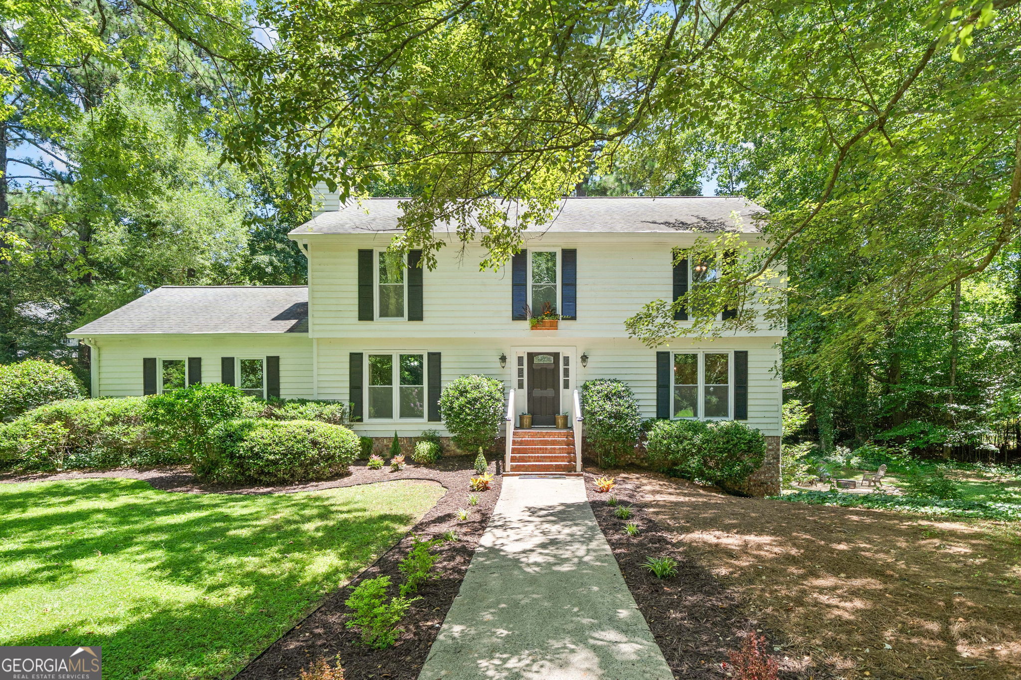 Welcome to this beautifully updated 5-bedroom, 3.5-bath home in the highly sought-after Walton High School district, tucked away on a quiet cul-de-sac in an established East Cobb neighborhood. Set on a peaceful, wooded lot with no HOA, you'll immediately appreciate the privacy and beautiful nature surroundings. This home is perfect for buyers wanting to live in the desirable school zone of Walton High which has been ranked among Georgia's Top 10 high schools for over 20 years by U.S. News & World Report, and nearby Dickerson Middle was named the state's #1 middle school in 2024. Thoughtfully renovated while retaining classic East Cobb charm, the interior is spacious and filled with natural light. The inviting living room offers a cozy retreat with a painted brick fireplace, and the heart of the home-a modern kitchen with new tile flooring and appliances-flows seamlessly to the main living areas. Upstairs, the oversized owner's suite boasts its own private deck for morning coffee or evening relaxation. The fully finished daylight basement features a separate entrance, updated bath, and new flooring-ideal for a guest suite, home office, or income-producing rental. Outside, two additional private decks overlook a serene backyard oasis, and the generous side yard is ready for entertaining family and friends at the large firepit or with enough space if you wanted to add a play area. The huge front lawn offers tons of curb appeal with a freshly landscaped yard and walkway leading to the new front door. Friendly neighbors and optional membership at Indian Hills Country Club add to the community appeal. Just 12 minutes from Truist Park and within easy reach of Sandy Springs, Buckhead, Roswell, and more, this East Cobb gem offers the perfect blend of privacy, top-ranked schools, quality construction, and prime location. Don't miss your chance to call 411 Woodstone West Drive home!